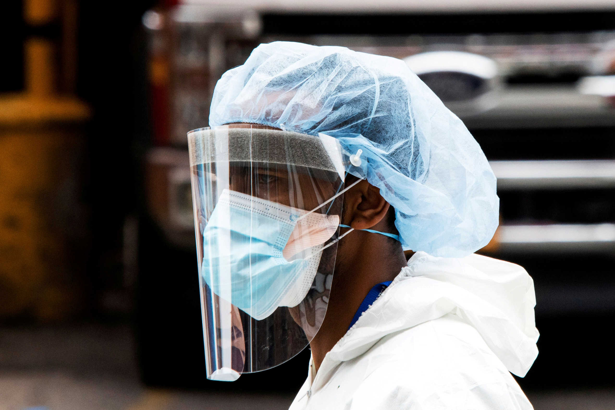 FILE PHOTO: A person wearing a PPE suit exits the Elmhurst Hospital center as the outbreak of coronavirus disease (COVID-19) continues in the neighborhood of Queens in New York, U.S., April 5, 2020. REUTERS