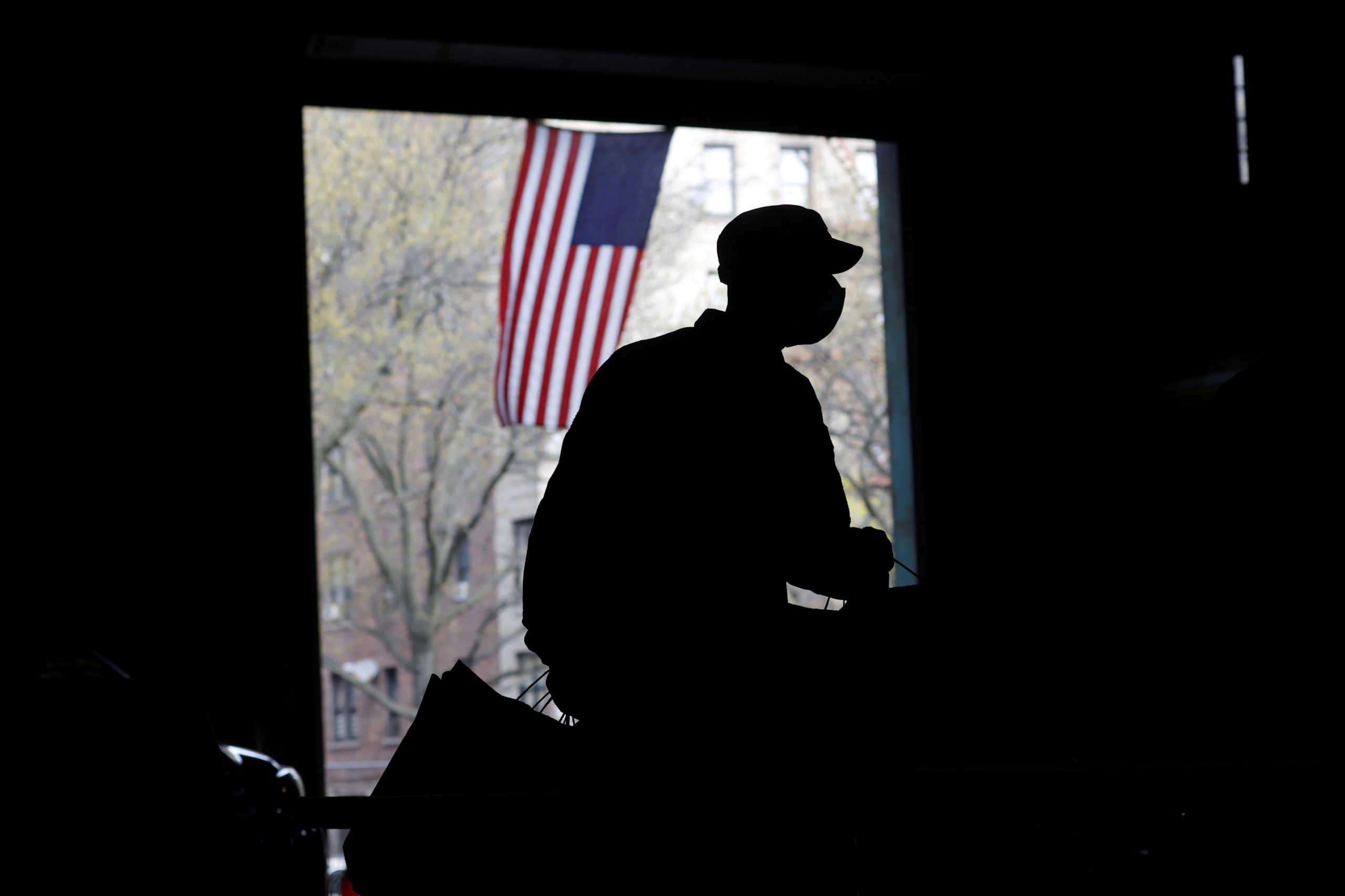A U.S. Army National Guard soldier wears a protective face mask while working to load food into vehicles at the Kingsbridge Armory which is being used as a temporary food distribution center during the outbreak of the coronavirus disease (COVID-19) in the Bronx borough of New York City, New York, U.S., April 21, 2020. REUTERS