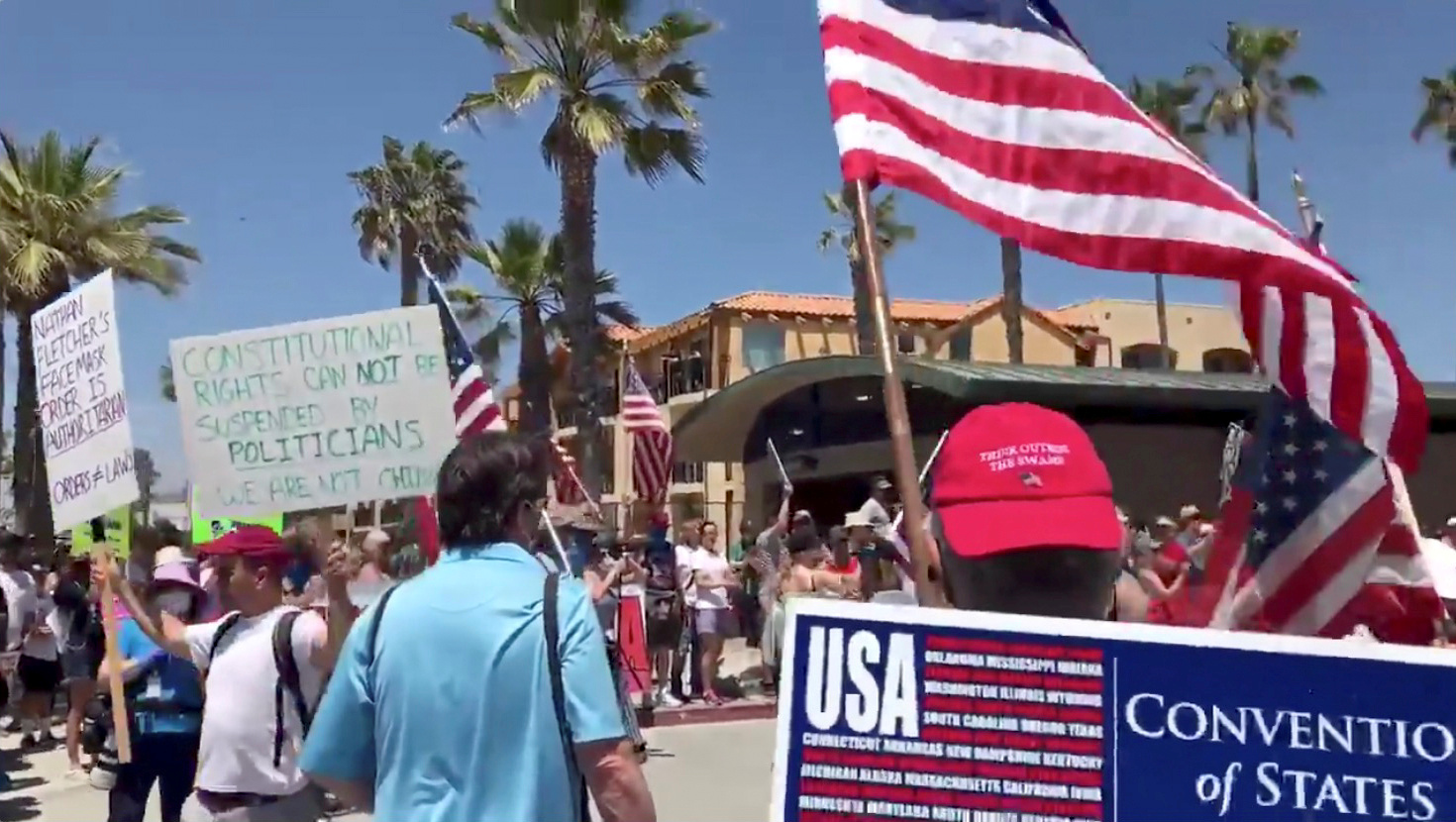 People rally for the U.S. and call for the end of the lockdown in San Diego, California, amid the coronavirus disease (COVID-19) outbreak in the U.S., April 26, 2020, in this still image from video obtained via social media. Kelly Neill via REUTERS   ATTENTION EDITORS - THIS IMAGE HAS BEEN SUPPLIED BY A THIRD PARTY. MANDATORY CREDIT. NO RESALES. NO ARCHIVES.