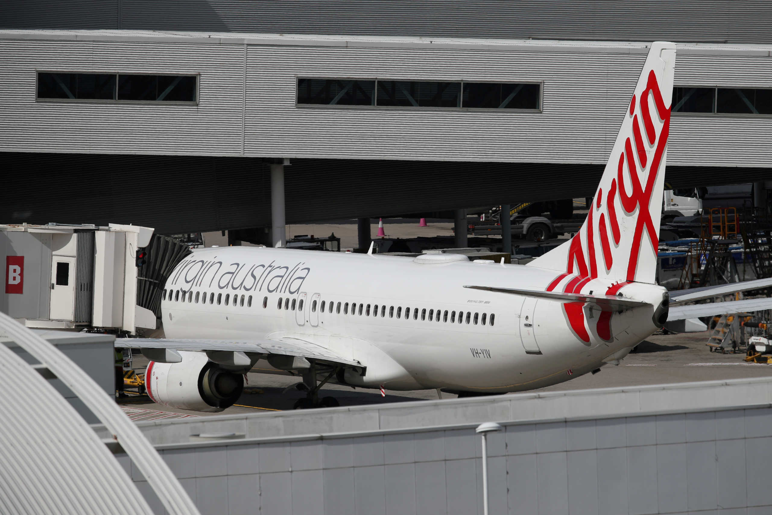 FILE PHOTO: A Virgin Australia plane at Kingsford Smith International Airport the morning after Australia implemented an entry ban on non-citizens and non-residents to curb the spread of the coronavirus, in Sydney, Australia, March 21, 2020.  REUTERS