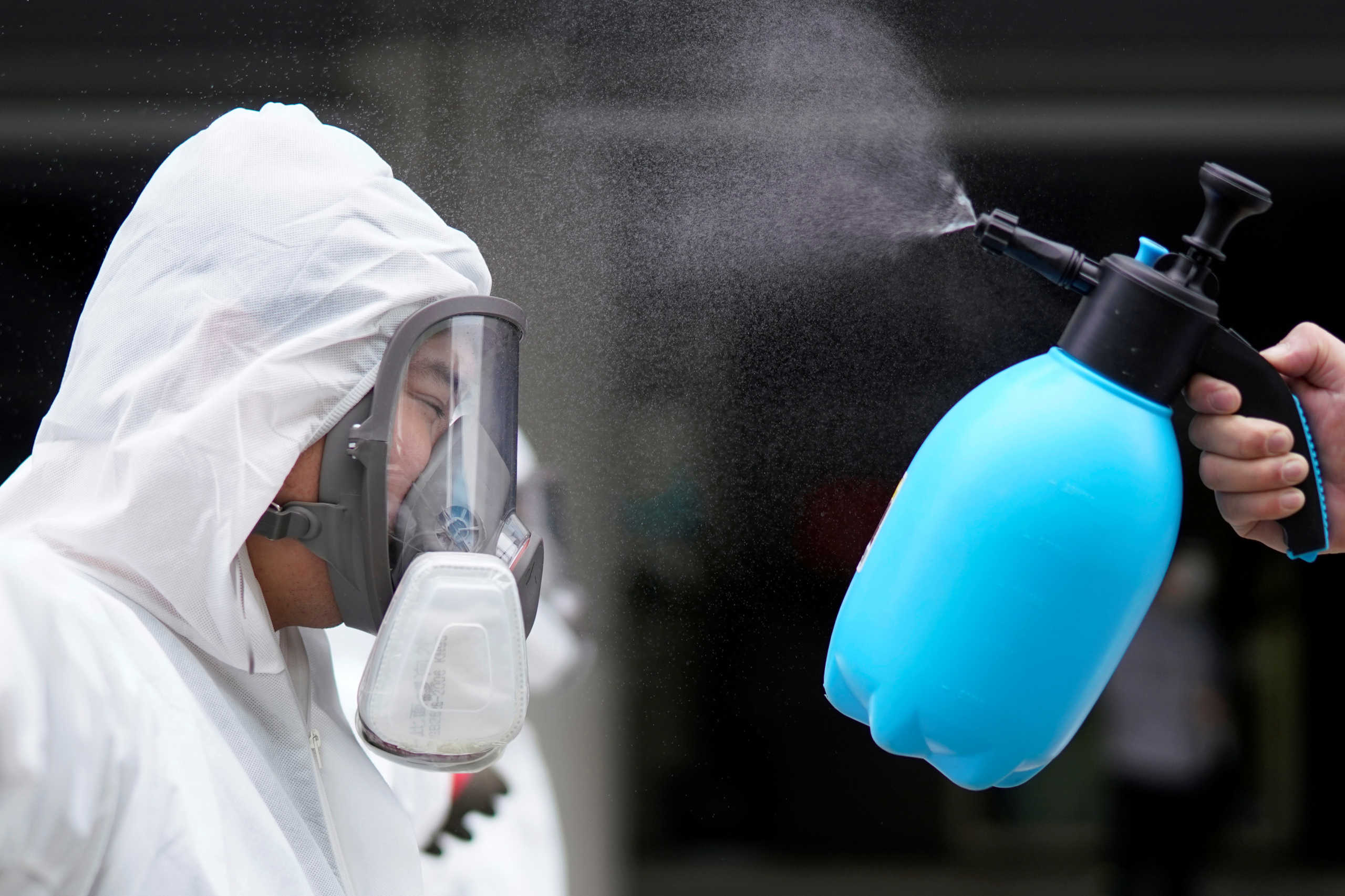 A volunteer from the Blue Sky Rescue team wearing a protective suit gets disinfected at the Qintai Grand Theatre in Wuhan, Hubei province, the epicentre of China's coronavirus disease (COVID-19) outbreak, April 2, 2020. Picture taken April 2, 2020. REUTERS
