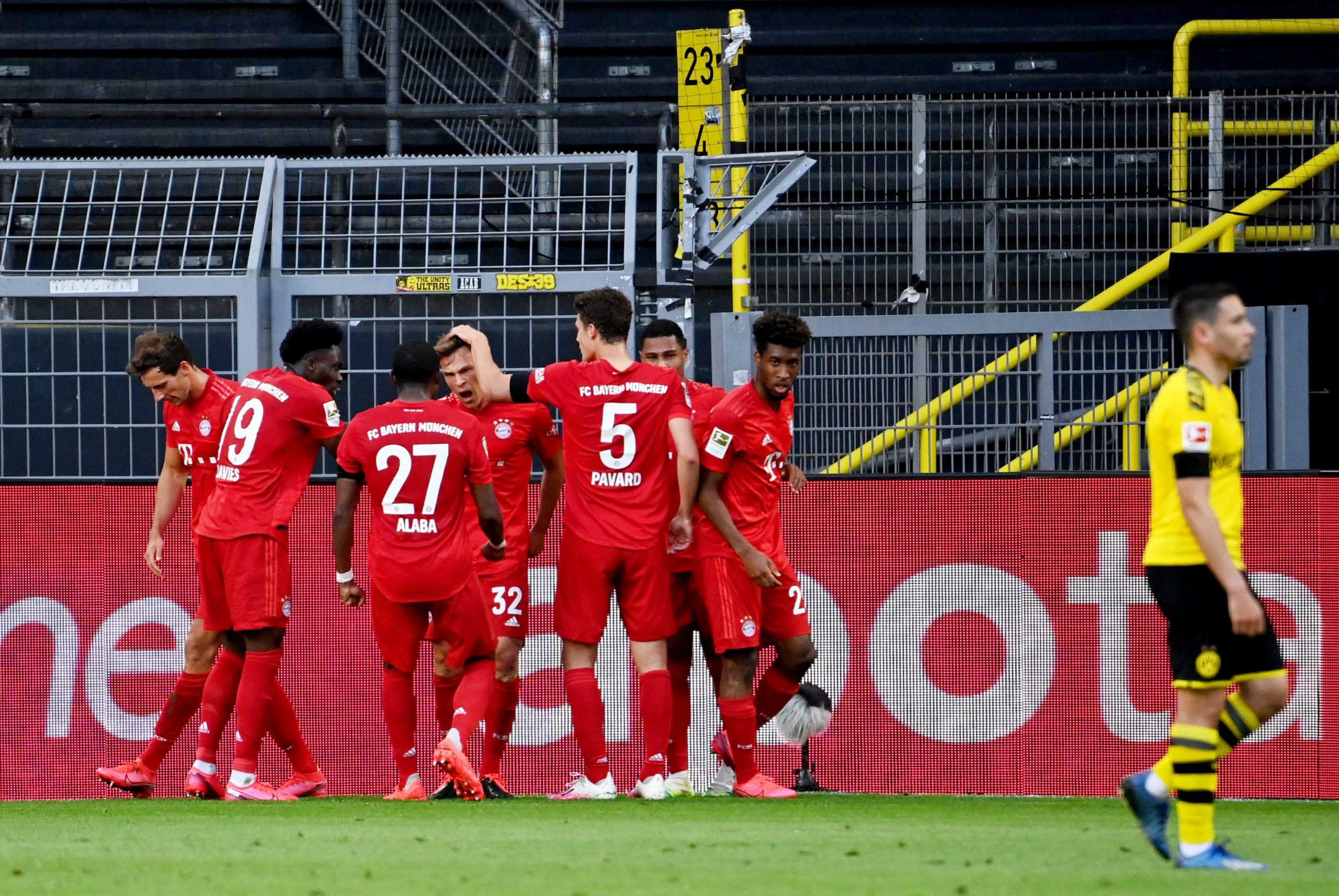 Soccer Football - Bundesliga - Borussia Dortmund v Bayern Munich - Signal Iduna Park, Dortmund, Germany - May 26, 2020 Bayern Munich's Joshua Kimmich celebrates scoring their first goal with teammates, as play resumes behind closed doors following the outbreak of the coronavirus disease (COVID-19) Federico Gambarini
