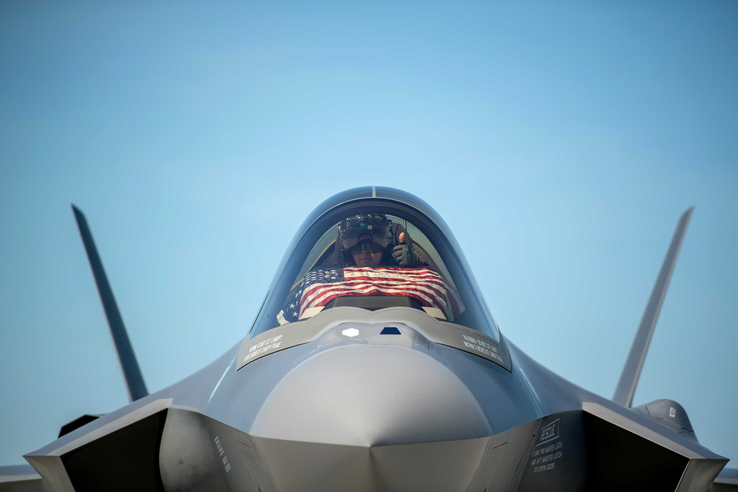 An F-35 pilot prepares for take off from the Vermont Air National Guard Base with the flag of the United States, before a flyover honoring Vermont’s front line coronavirus disease (COVID-19) responders and essential workers in South Burlington, Vermont, U.S. May 22, 2020. Picture taken May 22, 2020.  U.S. Air National Guard
