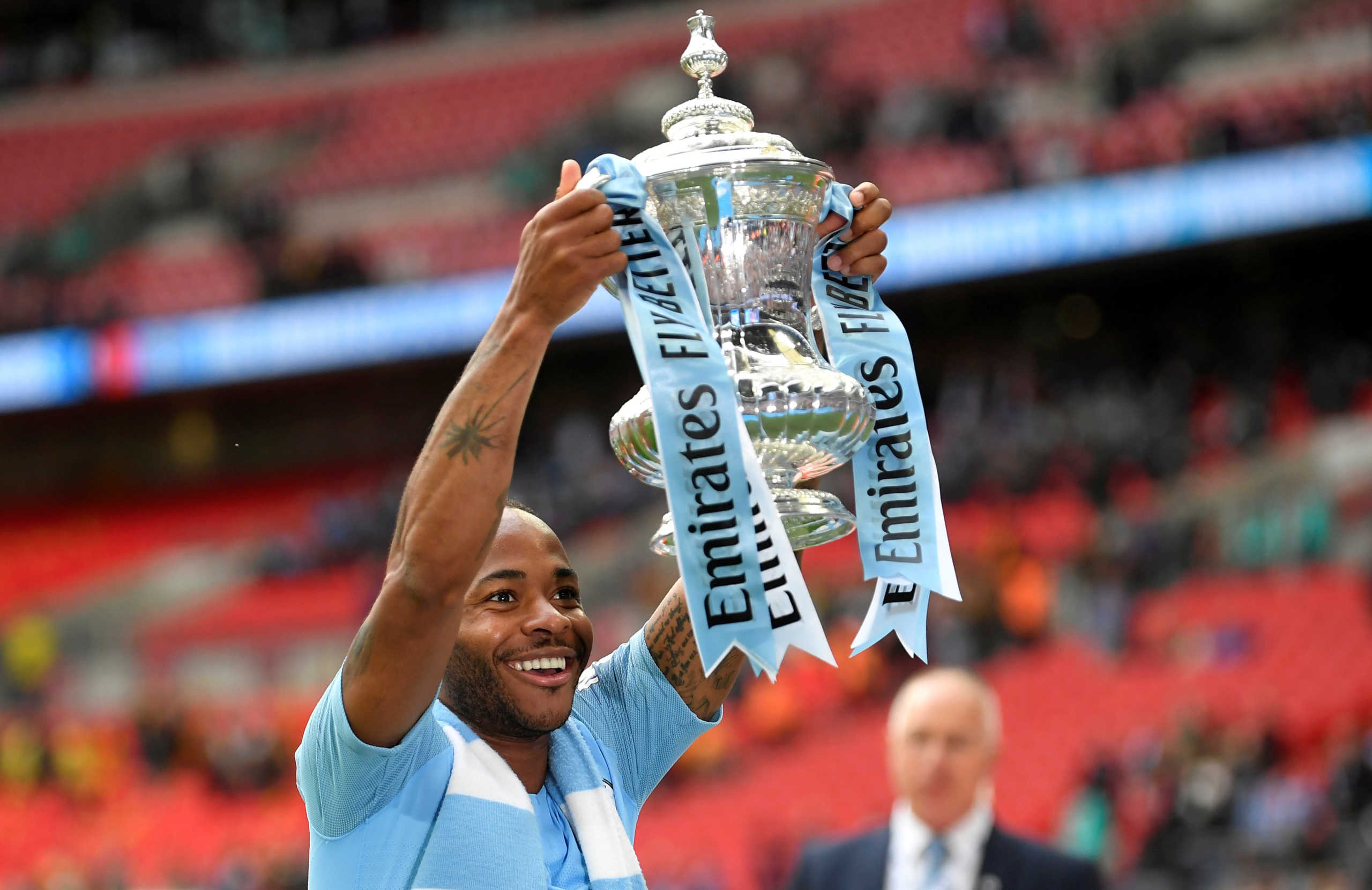 FILE PHOTO: Soccer Football - FA Cup Final - Manchester City v Watford - Wembley Stadium, London, Britain - May 18, 2019  Manchester City's Raheem Sterling celebrates winning the FA Cup final with the trophy  REUTERS