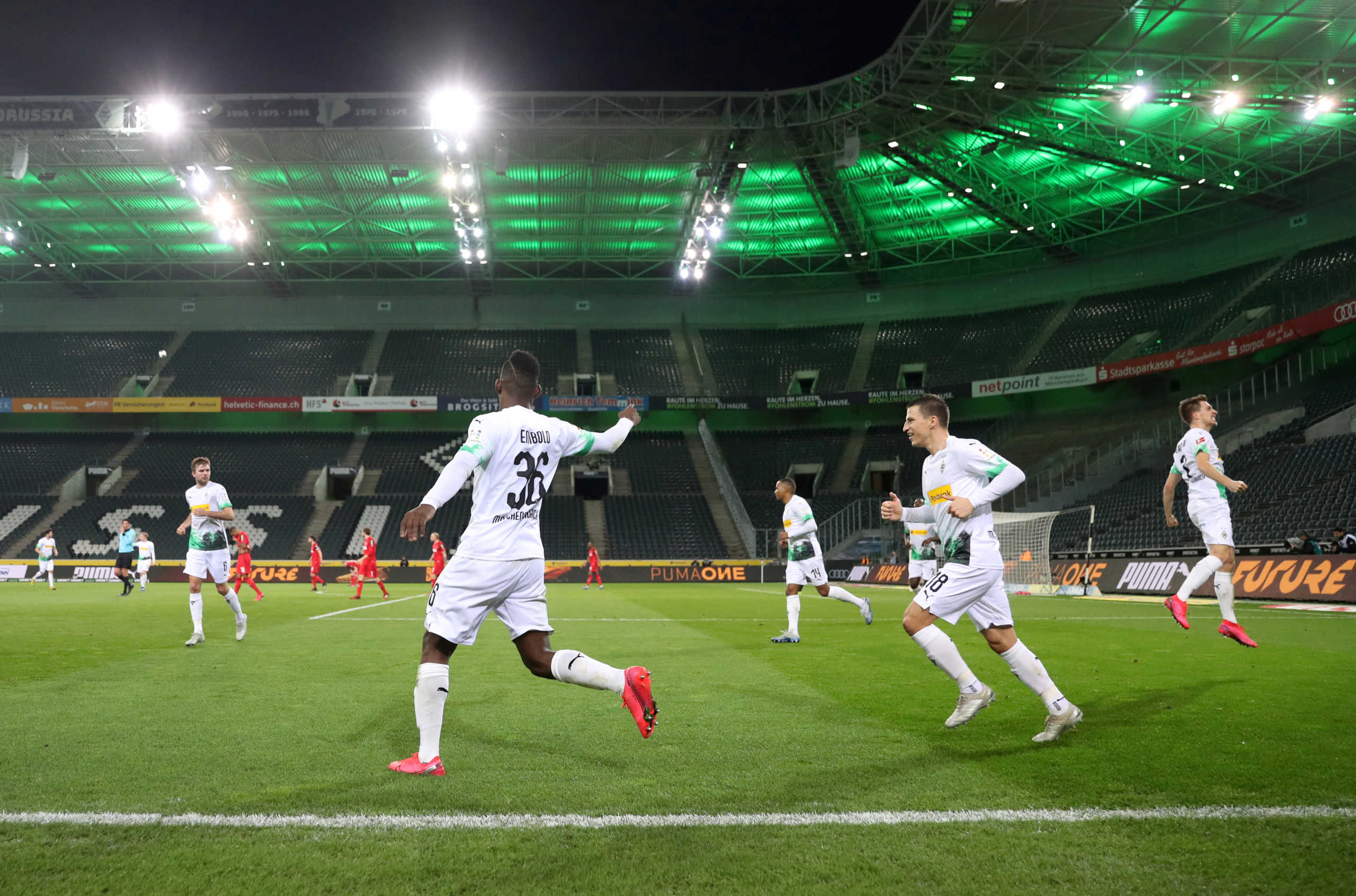 FILE PHOTO: Soccer Football - Bundesliga - Borussia Moenchengladbach v FC Cologne - Borussia-Park, Moenchengladbach, Germany - March 11, 2020  Borussia Moenchengladbach's Breel Embolo celebrates scoring their first goal with Stefan Lainer and teammates during the match being played behind closed doors while the number of coronavirus cases grow around the world  REUTERS
