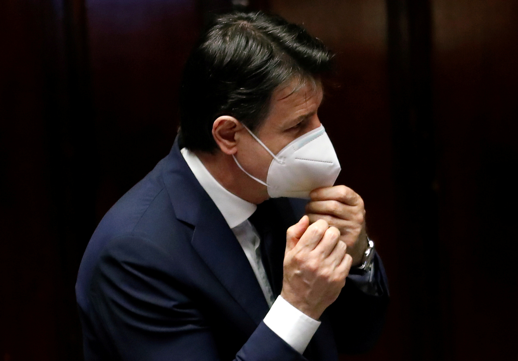 FILE PHOTO: Italian Prime Minister Giuseppe Conte wears a face mask as he attends a session of the lower house of parliament on the coronavirus disease (COVID-19) in Rome, Italy April 21, 2020. REUTERS