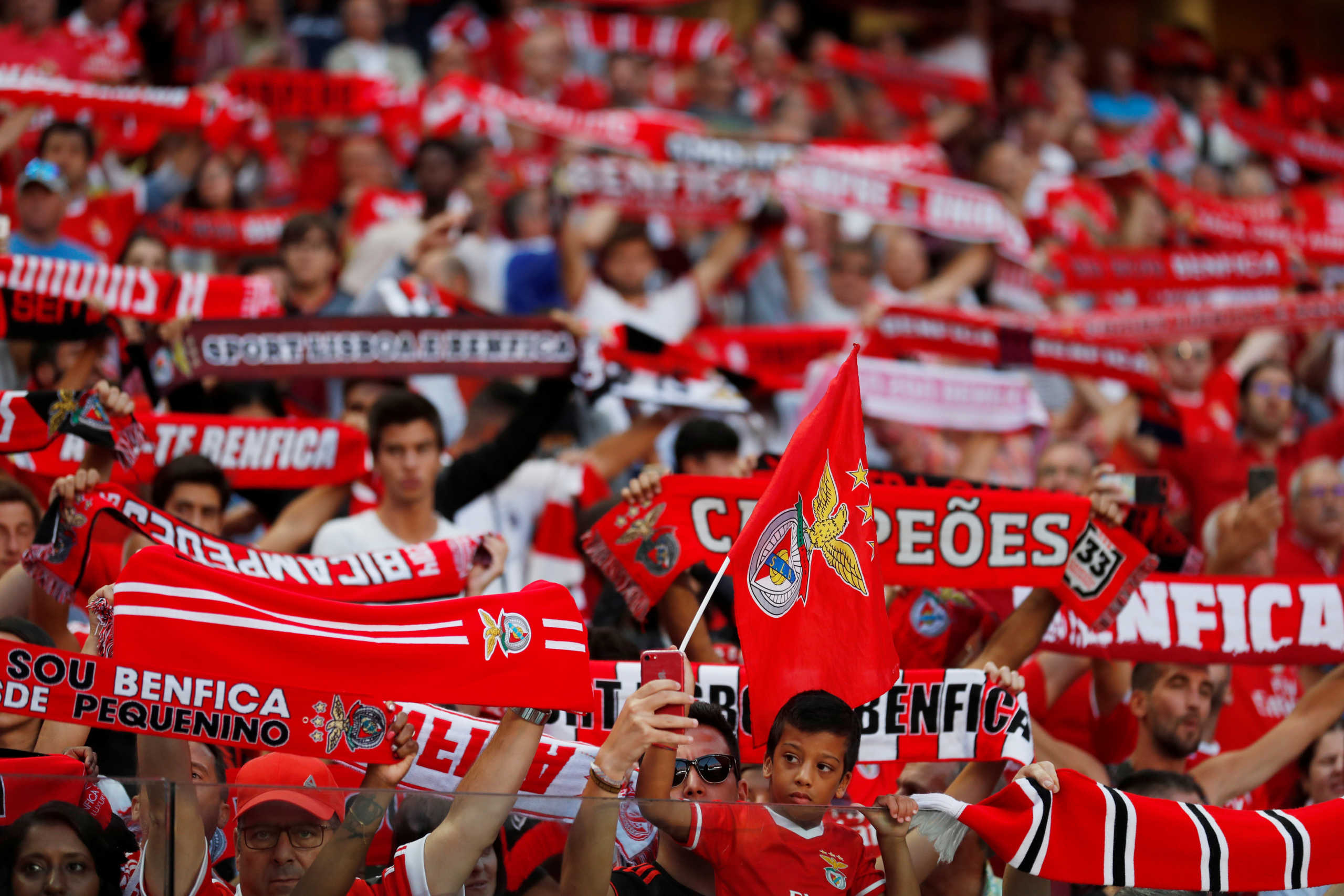 FILE PHOTO: Soccer Football - Primeira Liga - Benfica v Vitoria de Setubal - Estadio da Luz, Lisbon, Portugal - September 28, 2019   Benfica fans hold scarves in the air inside the stadium before the match    REUTERS