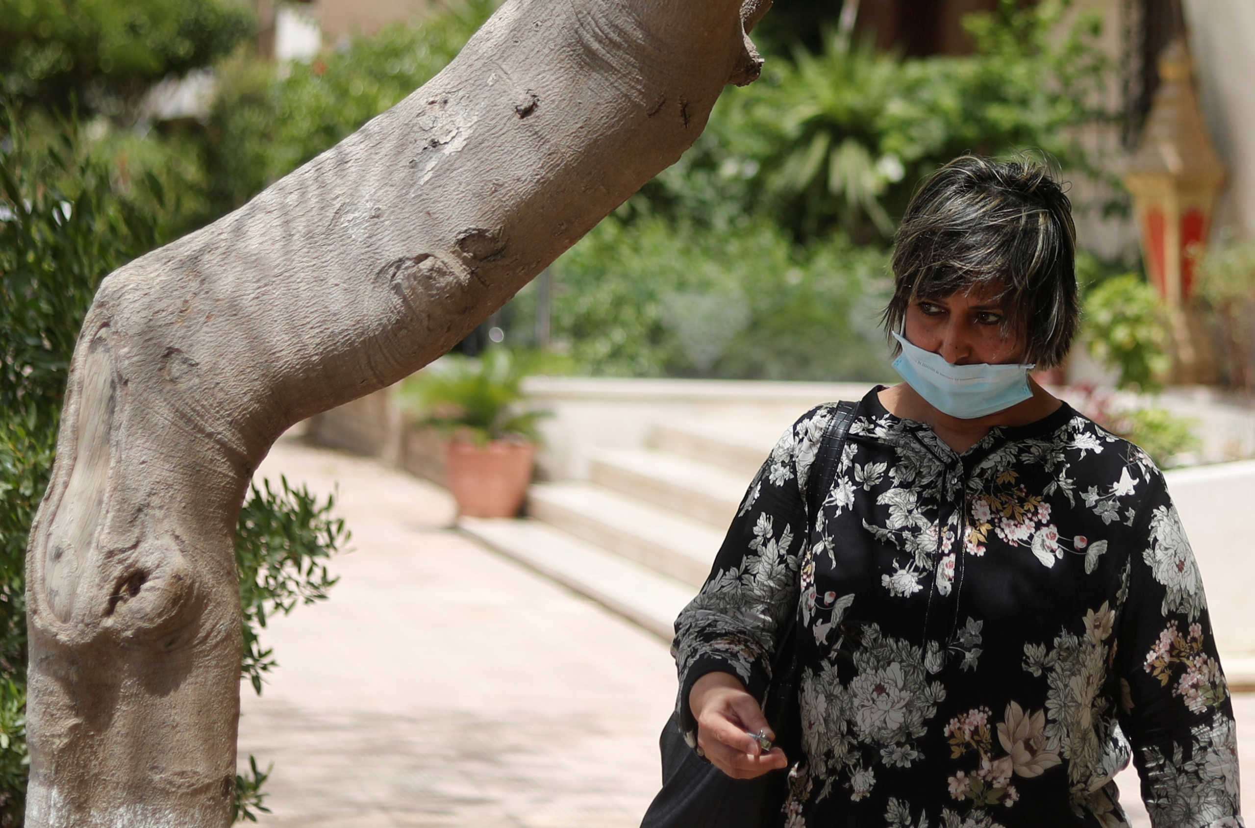A woman is pictured wearing a protective face mask, amid concerns over the coronavirus disease (COVID-19), before iftar, or breaking fast, during the holy month of Ramadan, in Cairo, Egypt May 21, 2020. REUTERS