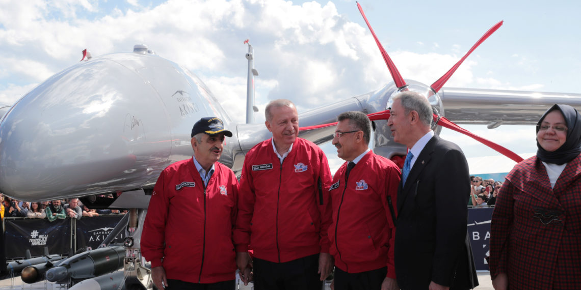 Turkish President Tayyip Erdogan, accompanied by Defense Minister Hulusi Akar and Vice President Fuat Oktay, poses next to Turkey's newest UAV (Unmanned Aerial Vehicle) Akinci as he visits Teknofest technology and aerospace fair in Istanbul, Turkey, September 21, 2019. Murat Cetinmuhurdar