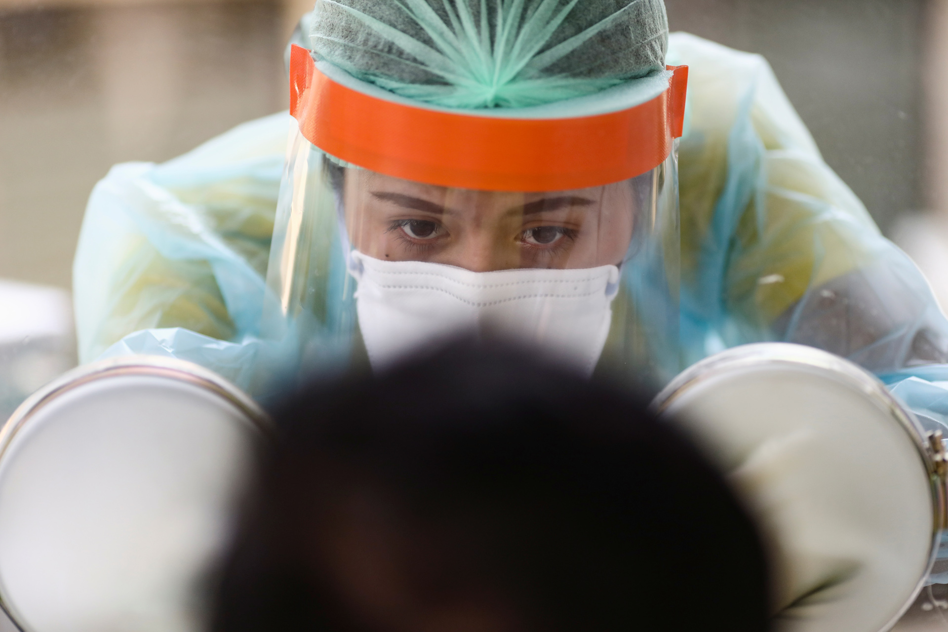 A medical personnel performs a nose swab test on a local resident of a community in Bangkok, amid the coronavirus disease (COVID-19) outbreak in Thailand, April 28, 2020. REUTERS