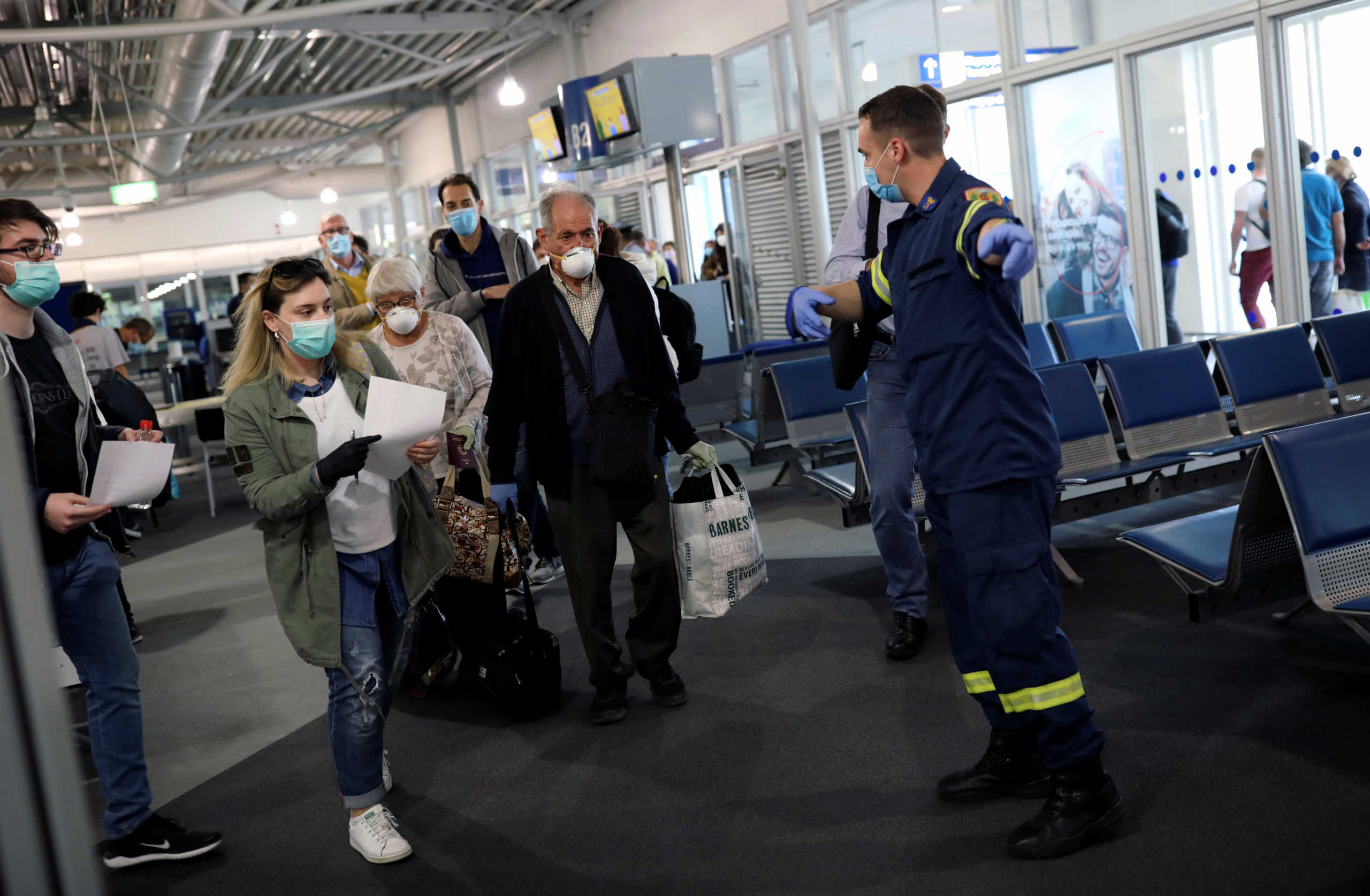 Passengers of the first Lufthansa flight to Greece, following a nationwide lockdown against the spread of the coronavirus disease (COVID-19), follow instructions upon their arrival at the Eleftherios Venizelos International Airport in Athens, Greece, May 18, 2020. REUTERS