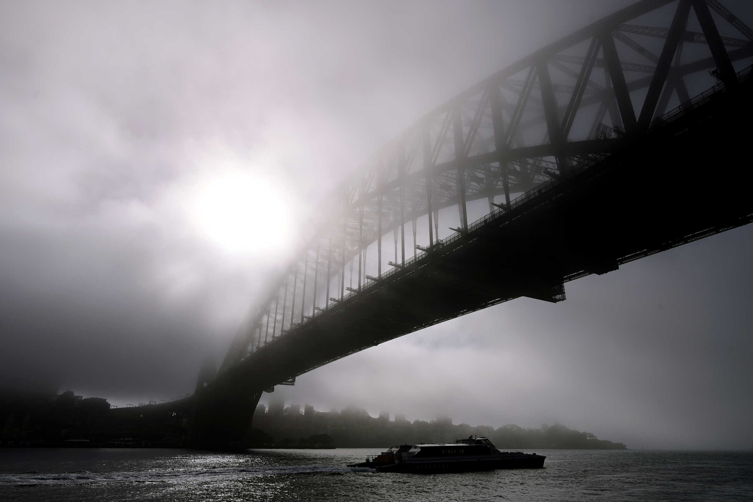 The Sydney Harbour Bridge is shrouded in morning fog in Sydney, Australia, May 19, 2020.  AAP Image