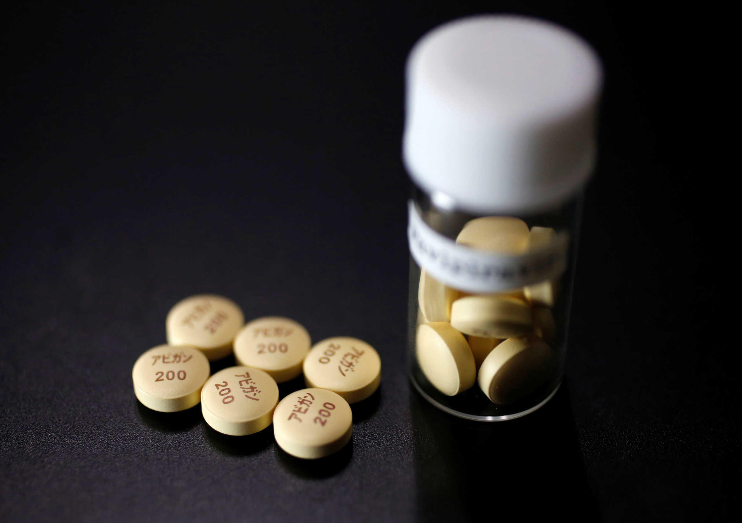 FILE PHOTO: Tablets of Avigan (generic name : Favipiravir), a drug approved as an anti-influenza drug in Japan and developed by drug maker Toyama Chemical Co, a subsidiary of Fujifilm Holdings Co. are displayed during a photo opportunity at Fujifilm's headquarters in Tokyo October 22, 2014. REUTERS