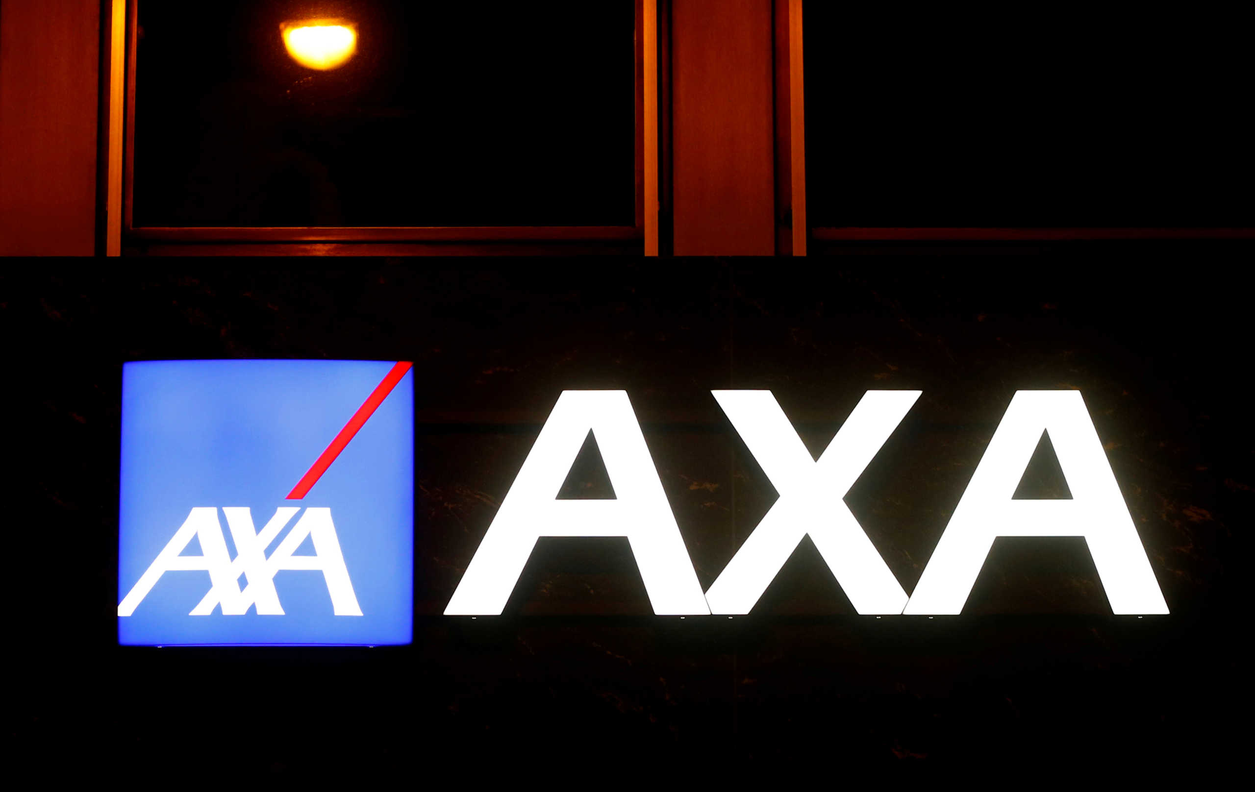 FILE PHOTO: The logo of AXA insurance is seen at an office building in Basel, Switzerland March 2, 2020. REUTERS