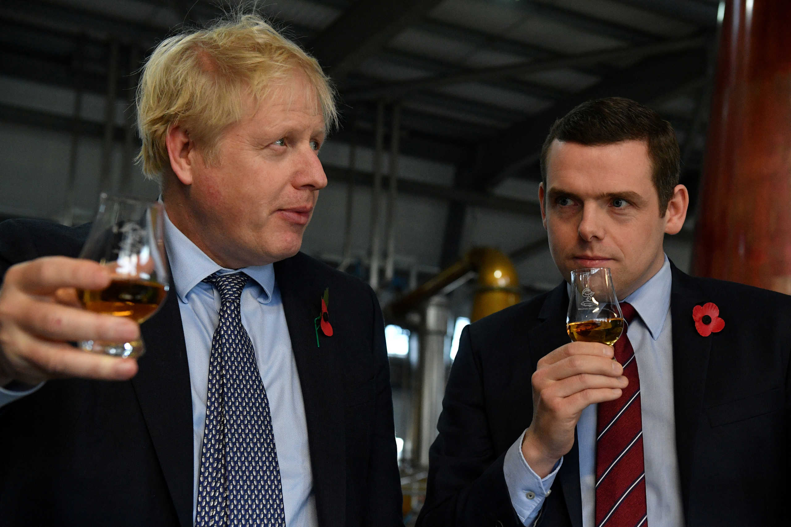 FILE PHOTO: Britain's Prime Minister Boris Johnson, (L), accompanied by Conservative party candidate for Moray, Douglas Ross, tastes whisky during a general election campaign visit to Diageo's Roseisle Distillery near Elgin, Scotland, Britain November 7, 2019. Daniel Leal-Olivas