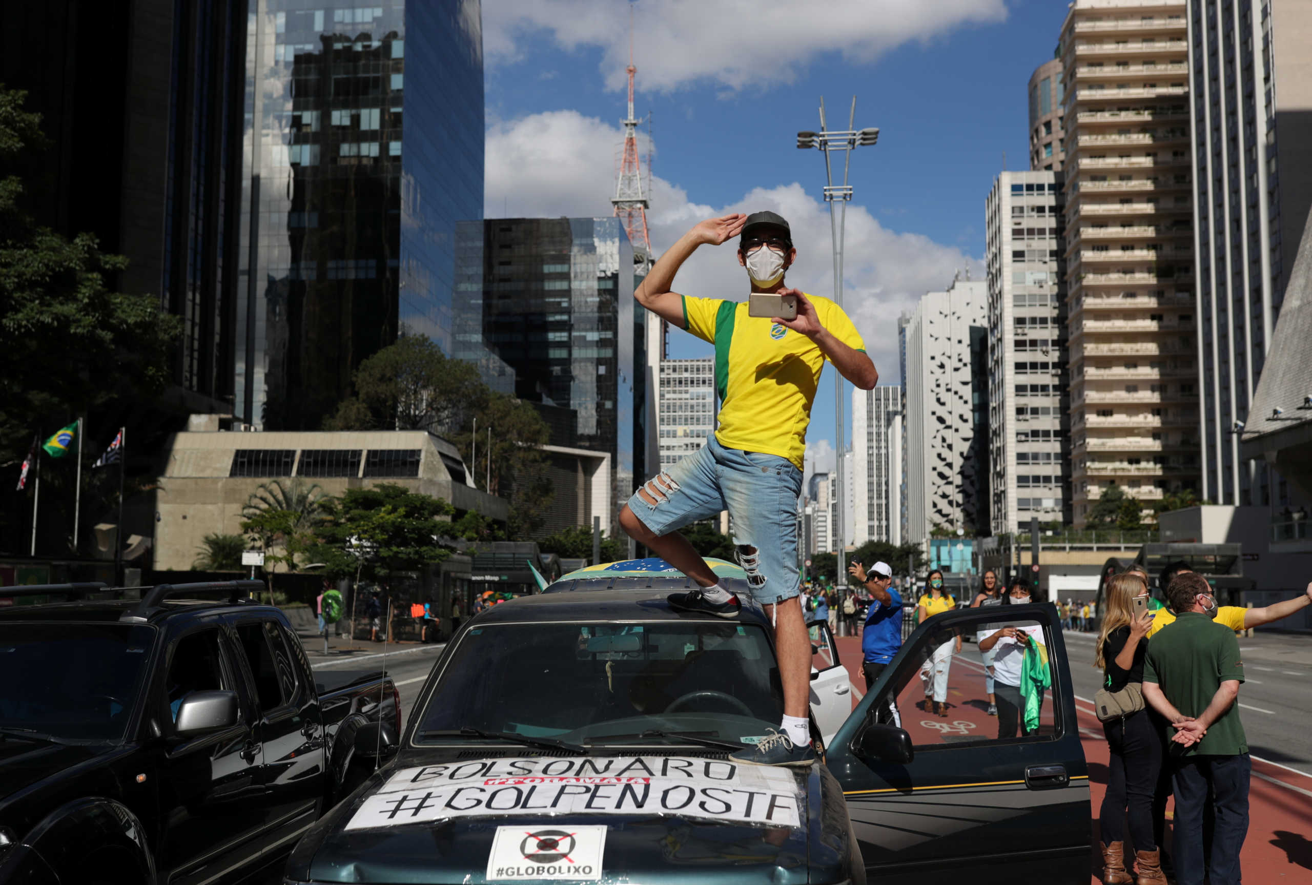 Supporters of far-right Brazilian President Jair Bolsonaro take part in a motorcade to protest against social distancing and quarantine measures, recommended by Sao Paulo's governor Joao Doria, following the coronavirus disease (COVID-19) outbreak, in Sao Paulo, Brazil, May 3, 2020. REUTERS