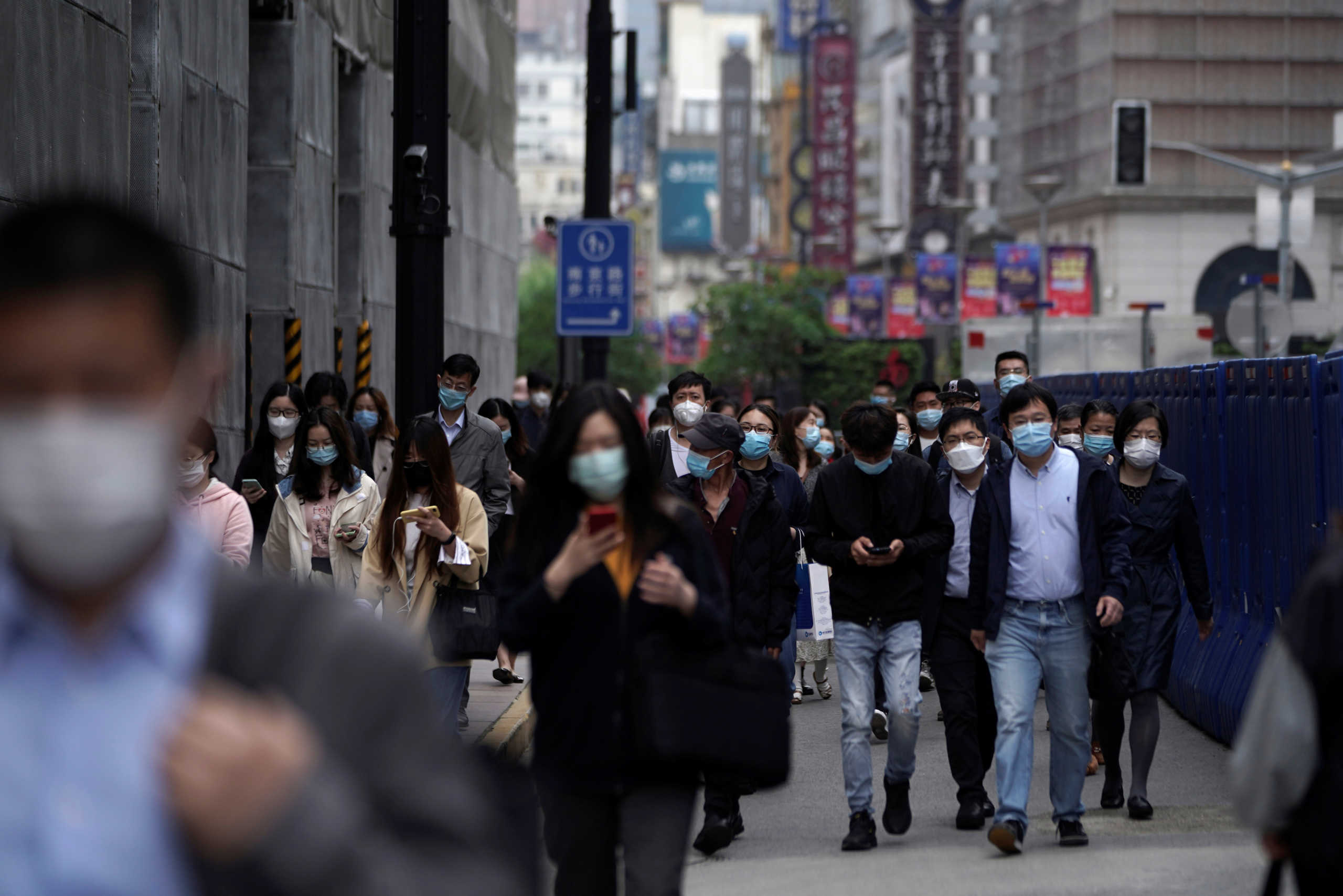 People wearing face masks walk at a main shopping area, following an outbreak of the novel coronavirus disease (COVID-19), in Shanghai, China May 6, 2020. REUTERS