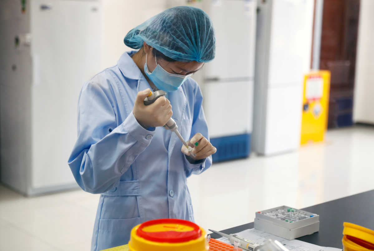 An employee works at the R&D laboratory of the Beijing Applied Biological Technologies Co. during a government organised tour of the facility following the outbreak of the new coronavirus disease (COVID-19), in Beijing, China, May 14, 2020. REUTERS