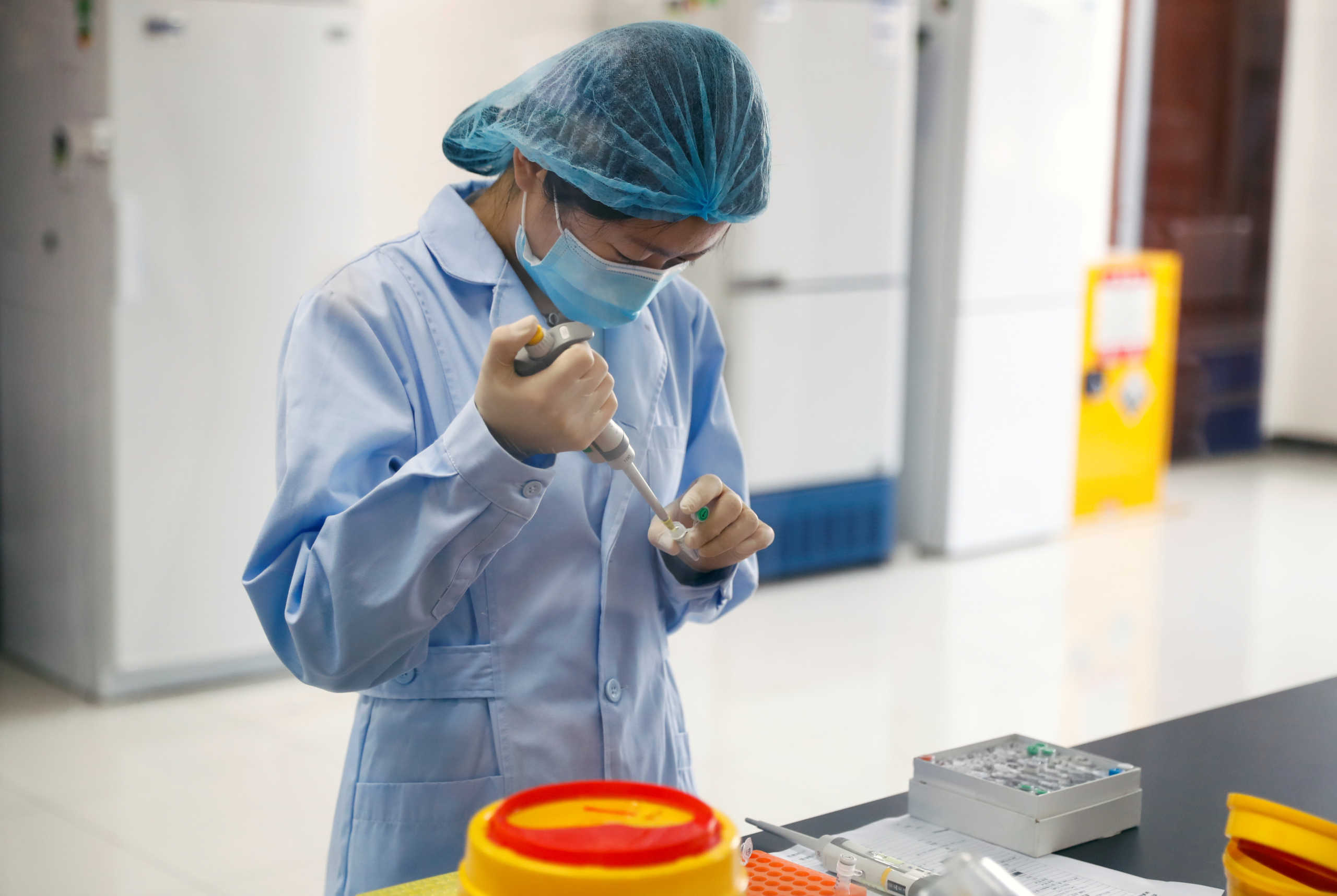 An employee works at the R&D laboratory of the Beijing Applied Biological Technologies Co. during a government organised tour of the facility following the outbreak of the new coronavirus disease (COVID-19), in Beijing, China, May 14, 2020. REUTERS
