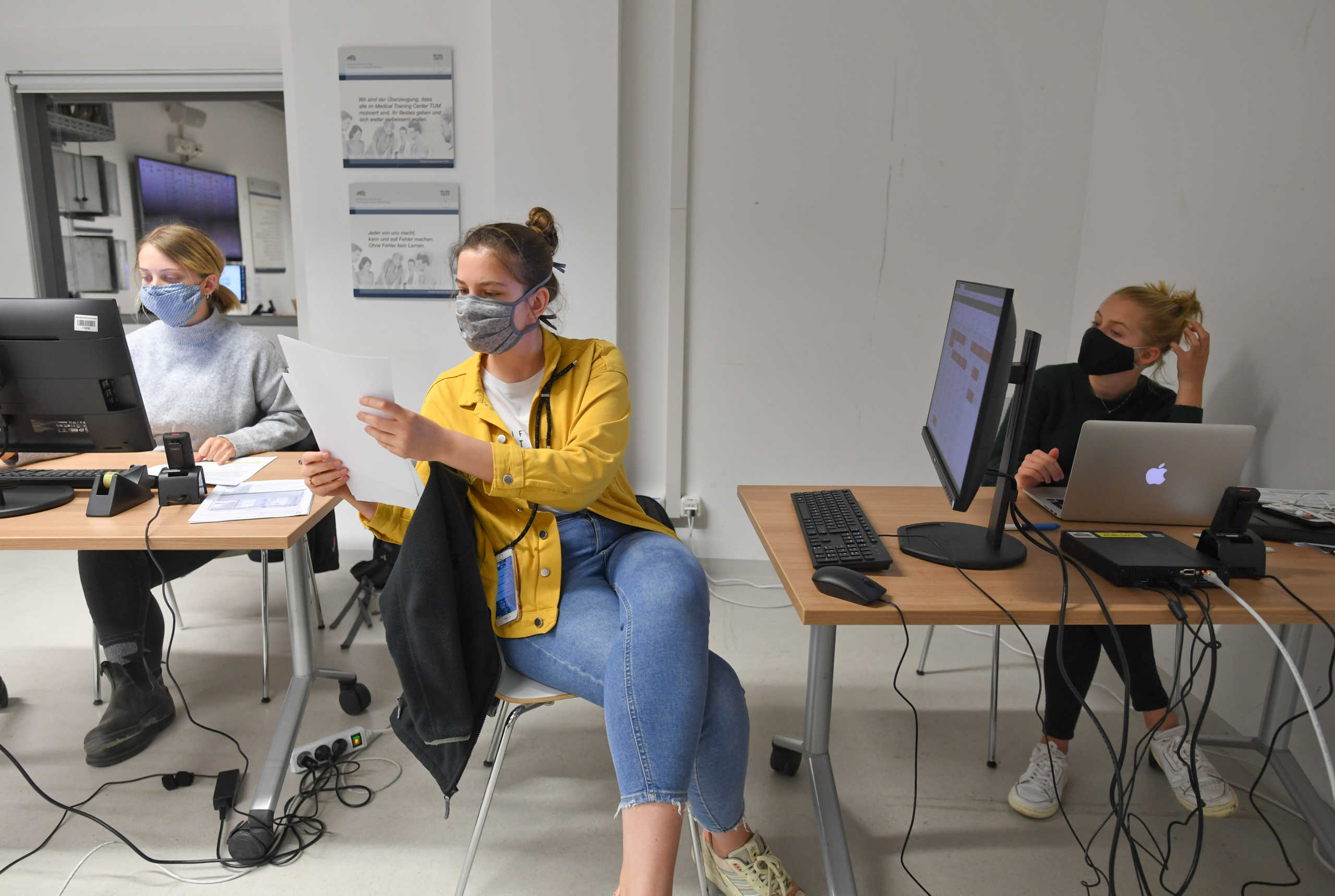 Students from the Technical University evaluate data from an ear sensor, designed to measure the biological values of COVID-19 patients in domestic isolation around the clock, as the spread of the coronavirus disease continues in Munich, Germany, May 6, 2020. Picture taken May 6, 2020. REUTERS