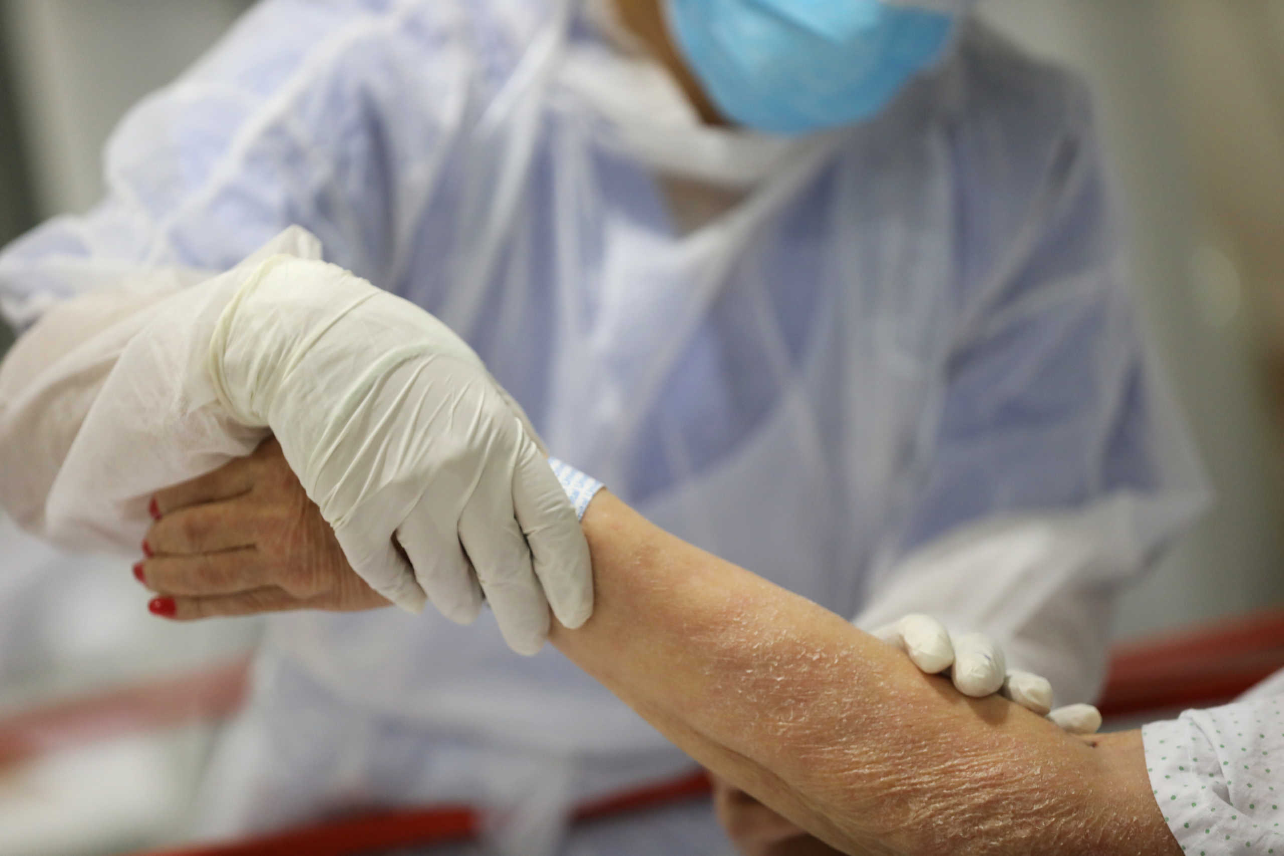 A healthcare worker treats an elderly patient at the emergency room as the spread of the coronavirus disease (COVID-19) continues, at Infanta Sofia University hospital in Madrid, Spain, May 8, 2020. REUTERS