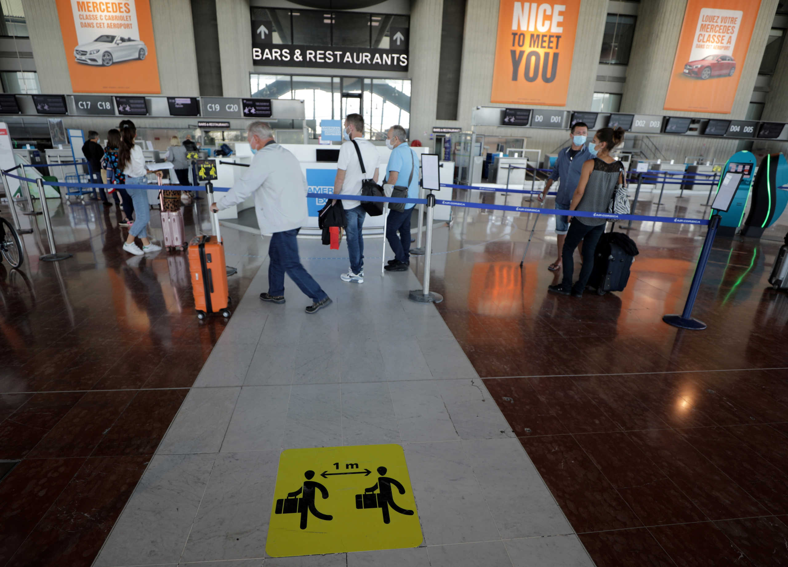 A sign reminding about social distancing is seen at Nice international airport during the outbreak of the coronavirus disease (COVID-19) in Nice, France, May 20, 2020. REUTERS