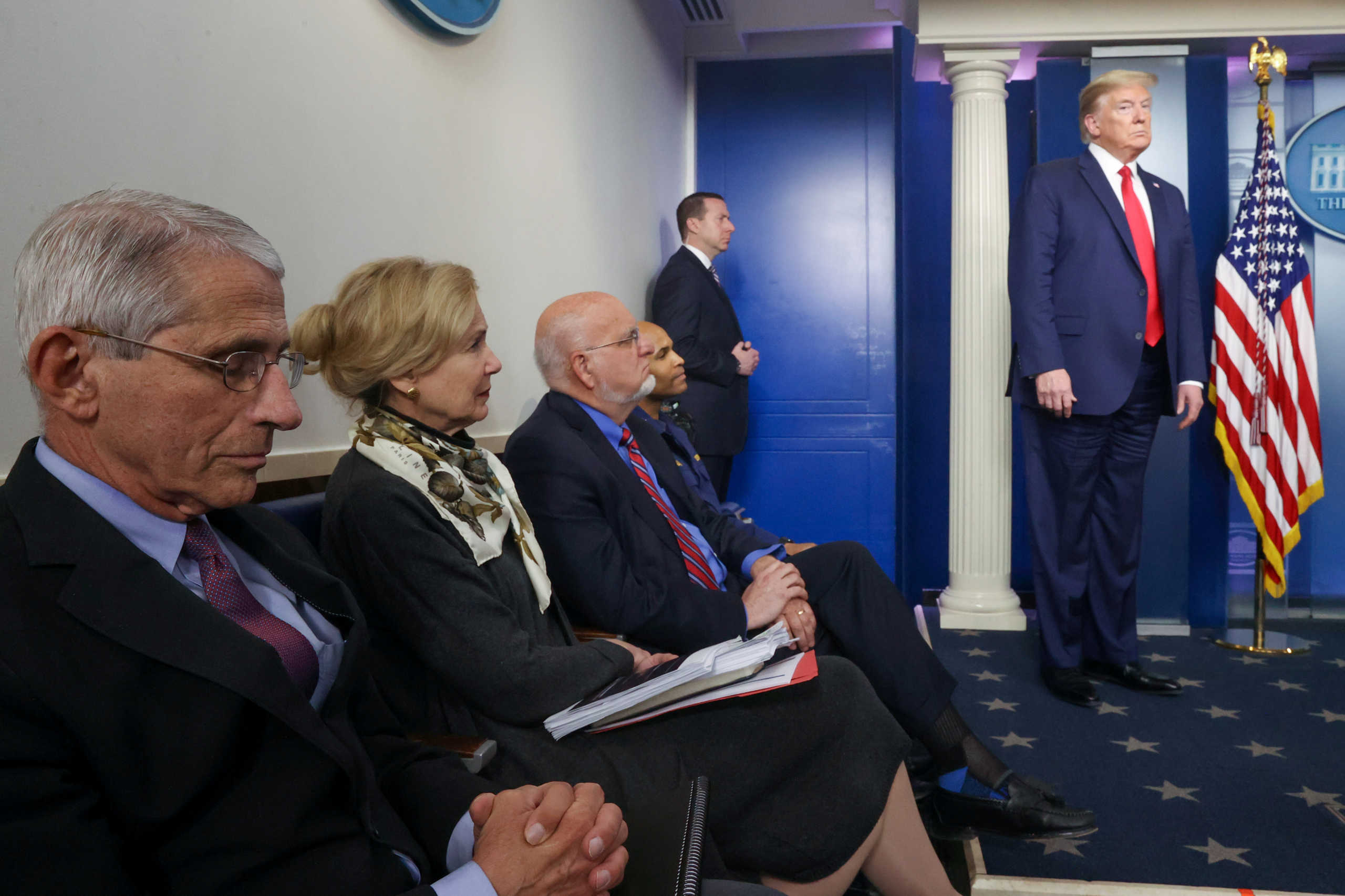 White House coronavirus task force members, including Dr. Anthony Fauci of the National Institutes of Health, White House coronavirus coordinator Dr. Deborah Birx, Centers for Disease Control (CDC) Director Robert Redfield and U.S. Surgeon General Jerome Adams listen to President Donald Trump during the daily coronavirus disease (COVID-19) briefing at the White House in Washington, U.S., April 22, 2020. Picture taken April 22, 2020. REUTERS