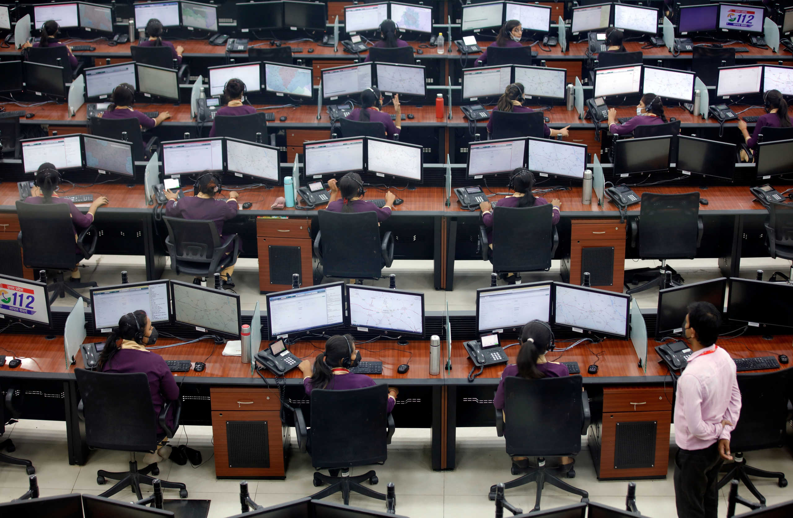 Employees wearing protective masks work inside a call centre run by Uttar Pradesh state police during an extended lockdown to slow the spreading of coronavirus disease (COVID-19) in Lucknow, India, April 21, 2020. REUTERS