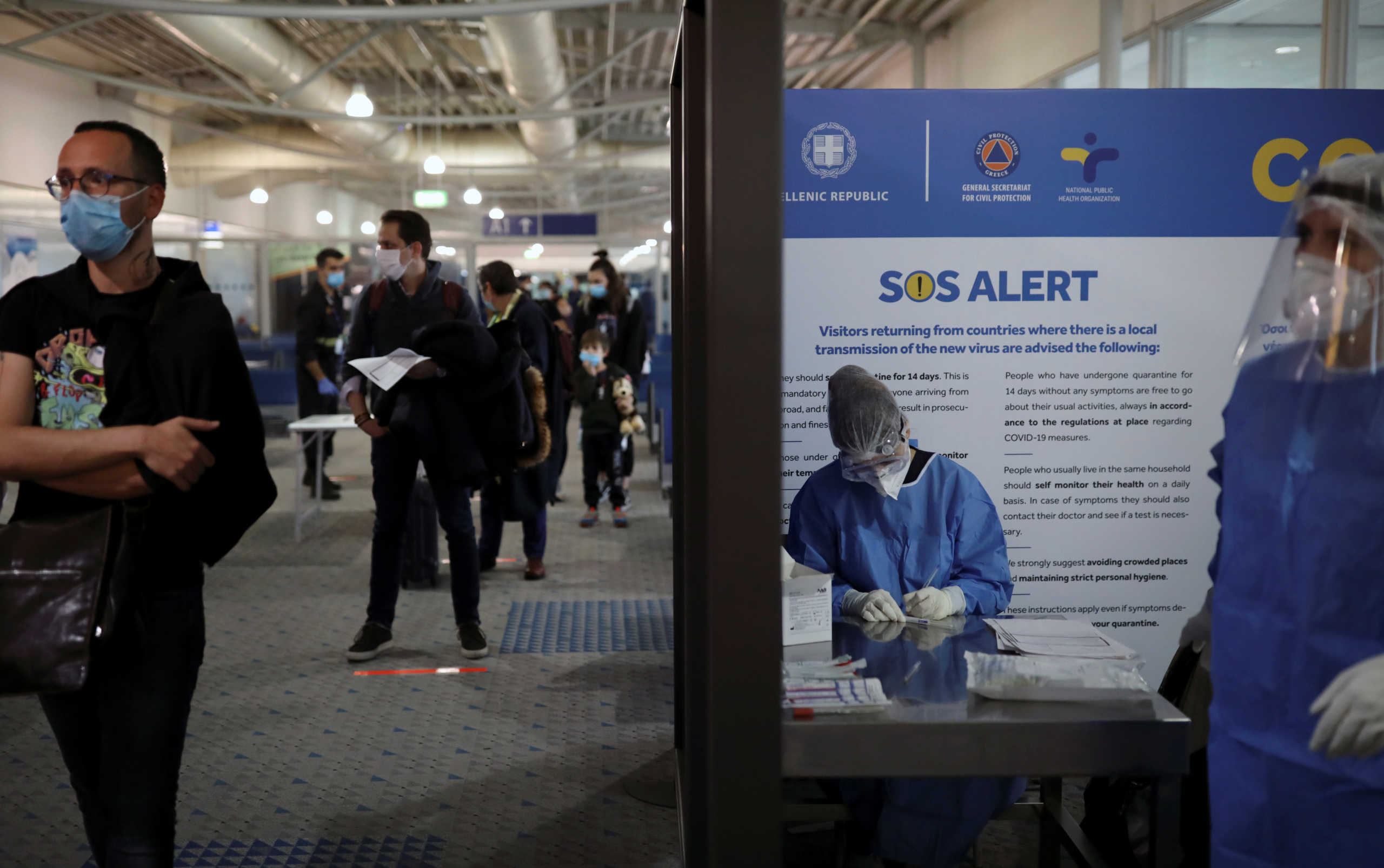 Passengers of the first Lufthansa flight to Greece, following a nationwide lockdown against the spread of the coronavirus disease (COVID-19), queue keeping social distance as they wait to be tested on the coronavirus disease (COVID-19), upon their arrival at the Eleftherios Venizelos International Airport in Athens, Greece, May 18, 2020. REUTERS