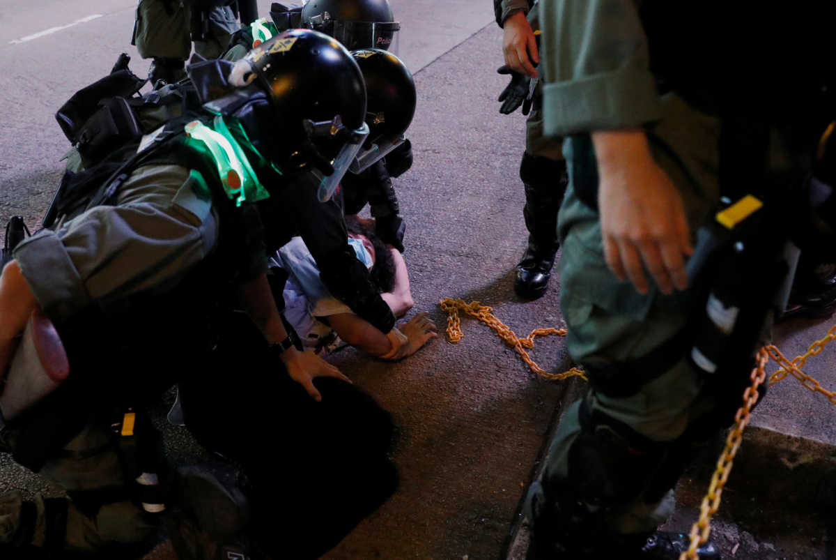 Riot police detain an anti-government protester during a protest at Mong Kok, in Hong Kong, China May 10, 2020. REUTERS