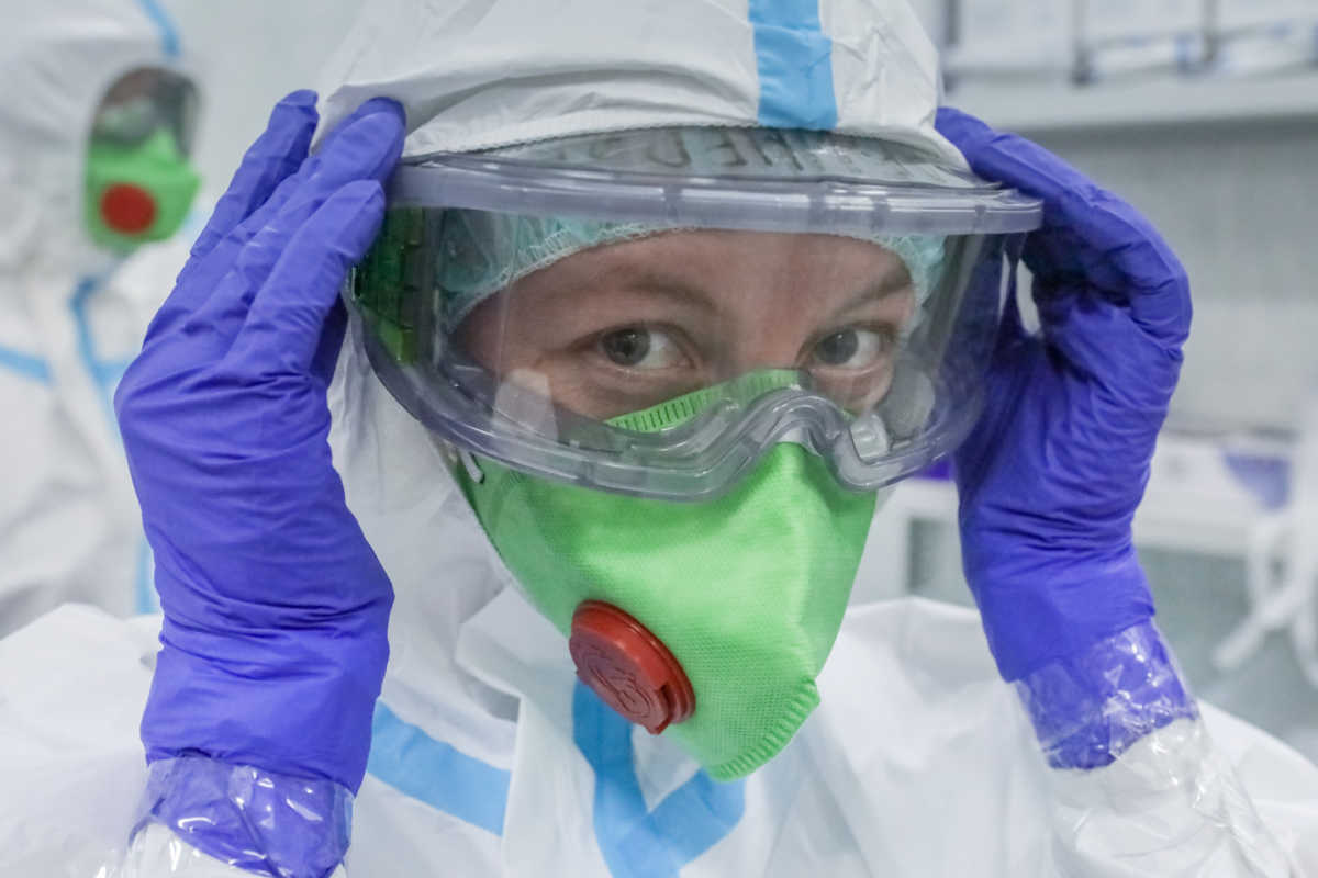 A medical specialist puts on personal protective equipment (PPE) in the Central Clinical Hospital "RZD-Medicine", which delivers treatment to patients infected with the coronavirus disease (COVID-19), in Moscow, Russia May 18, 2020. Sofya Sandurskaya