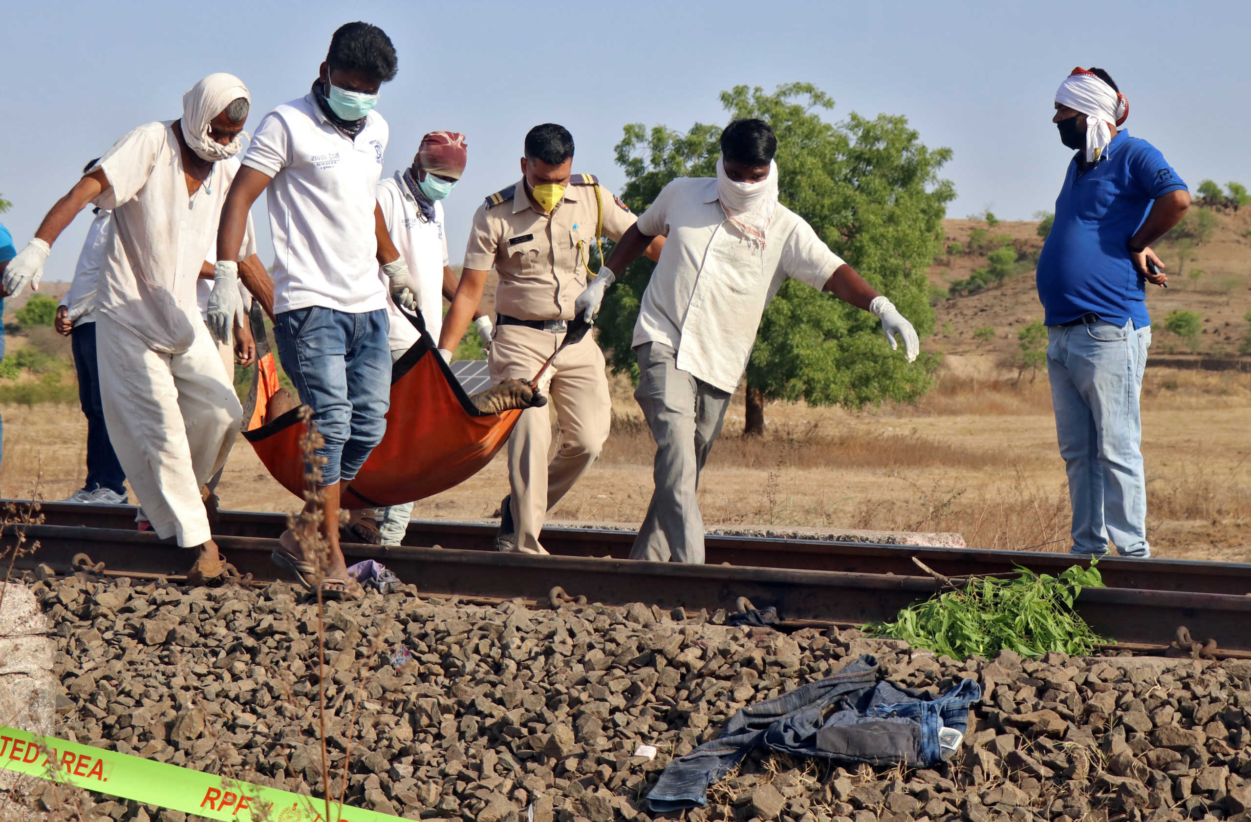 SENSITIVE MATERIAL. THIS IMAGE MAY OFFEND OR DISTURB   People carry the body of a victim after a train ran over migrant workers sleeping on the track in Aurangabad district in the western state of Maharashtra, India, May 8, 2020. REUTERS