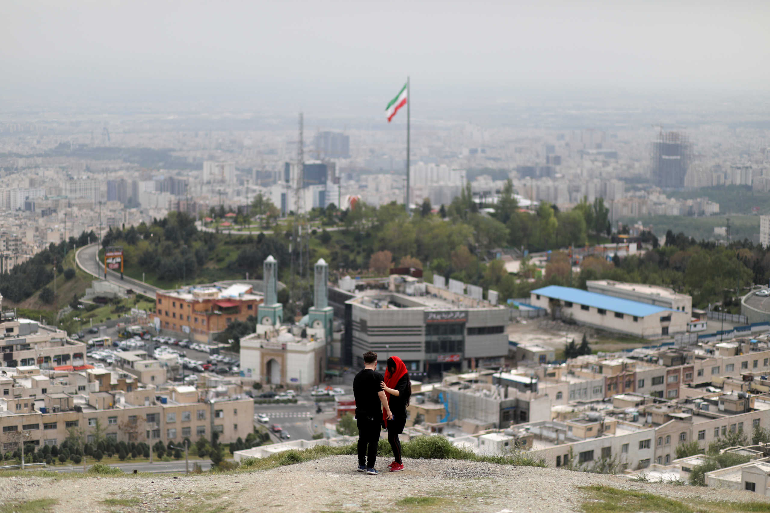 FILE PHOTO: An Iranian couple is seen following the outbreak of the coronavirus disease (COVID-19), in Tehran, Iran, April 30, 2020. WANA (West Asia News Agency)