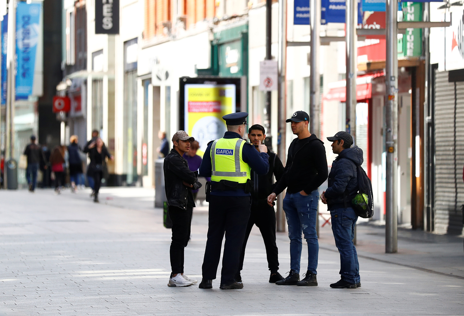 Garda officers speak to a group of young men in Dublin City Centre, following the outbreak of the coronavirus disease (COVID-19), Dublin, Ireland, May 1, 2020. REUTERS
