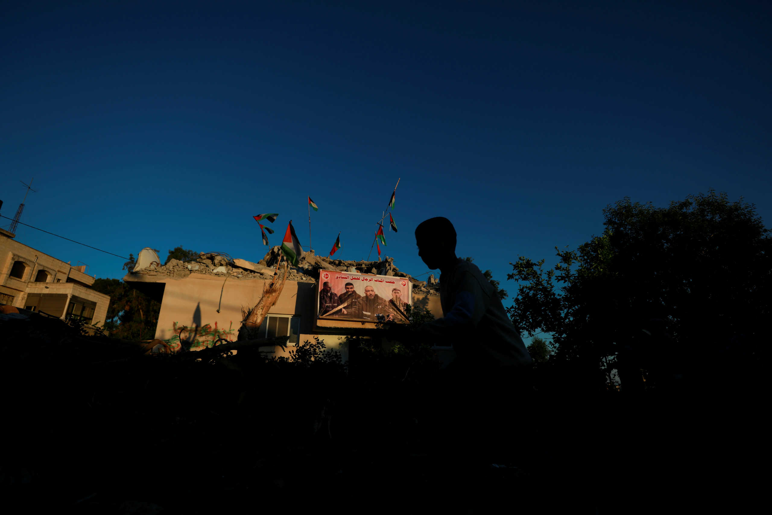 A boy walks past the house of Palestinian assailant Qassam Al-Barghouti after Israeli forces demolished its top floor in the village of Kobar near Ramallah in the Israeli-occupied West Bank May 11, 2020. REUTERS