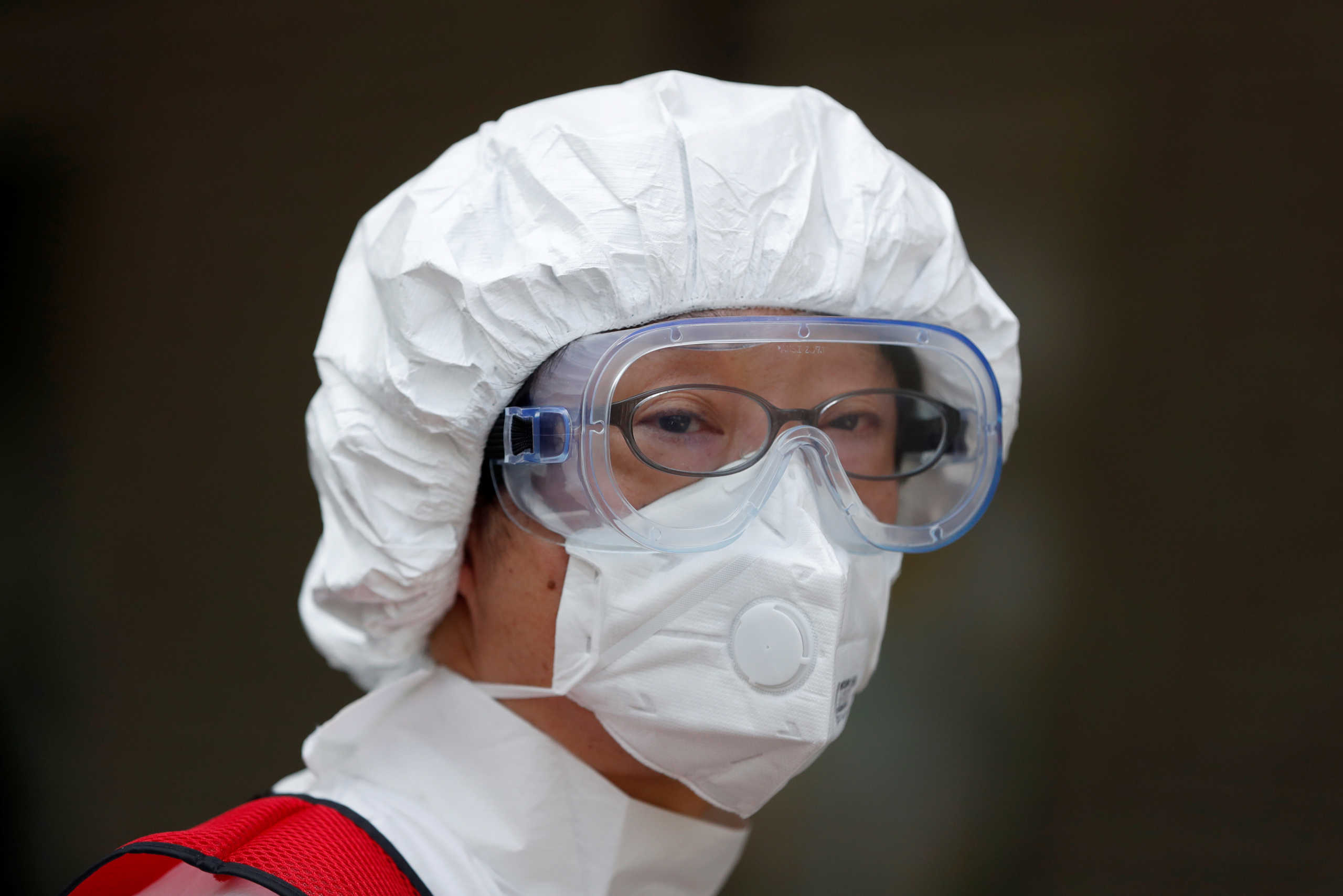 A doctor wearing an N95 mask prepares a mock test during a simulation for drive-through polymerase chain reaction (PCR) tests for the coronavirus disease (COVID-19) at Edogawa ward in Tokyo, Japan April 22, 2020.  REUTERS