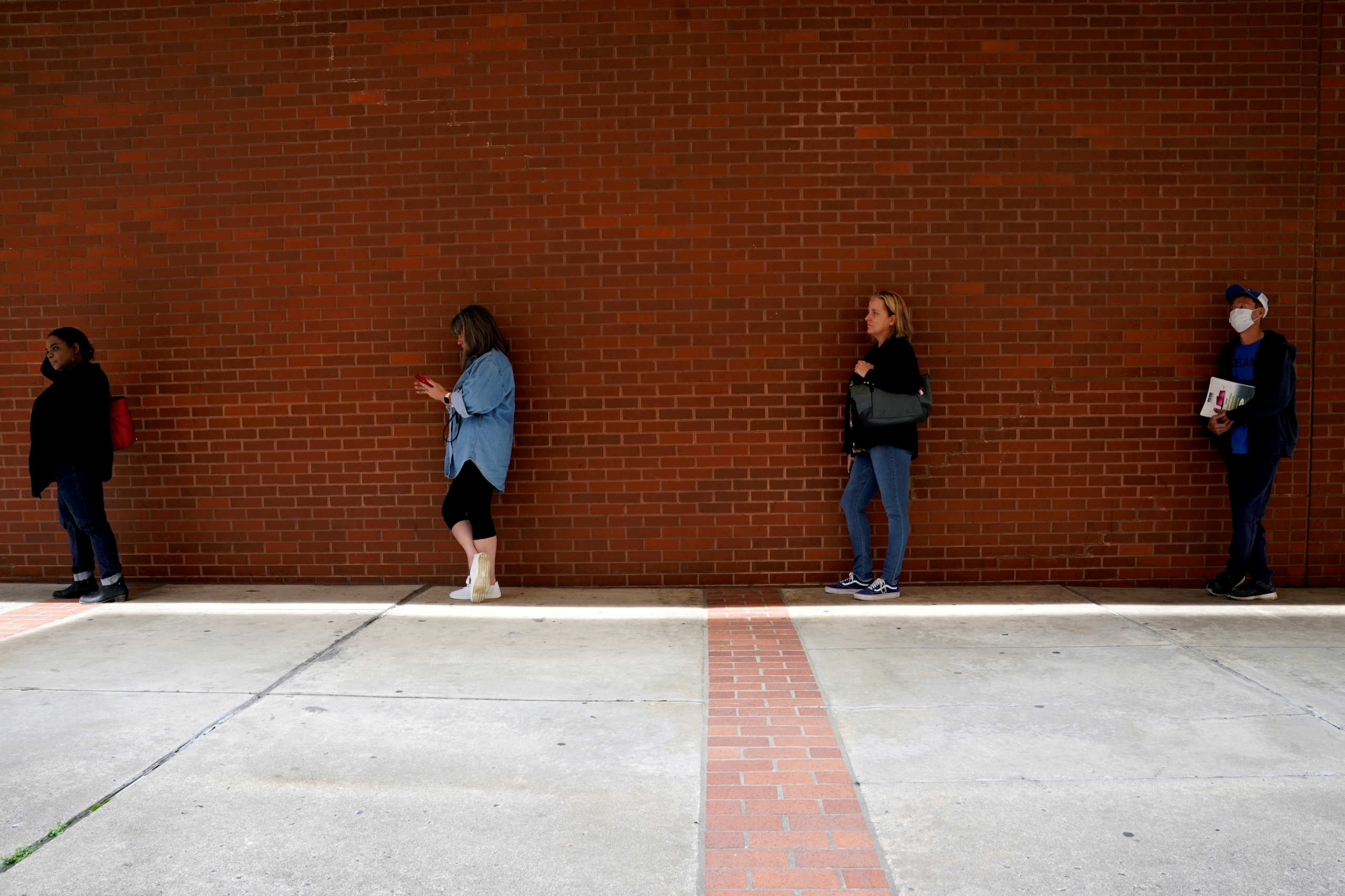 FILE PHOTO: People who lost their jobs wait in line to file for unemployment benefits, following an outbreak of the coronavirus disease (COVID-19), at Arkansas Workforce Center in Fort Smith, Arkansas, U.S. April 6, 2020. REUTERS