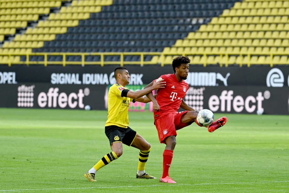 Soccer Football - Bundesliga - Borussia Dortmund v Bayern Munich - Signal Iduna Park, Dortmund, Germany - May 26, 2020 Bayern Munich's Kingsley Coman in action with Borussia Dortmund's Mahmoud Dahoud, as play resumes behind closed doors following the outbreak of the coronavirus disease (COVID-19) Federico Gambarini