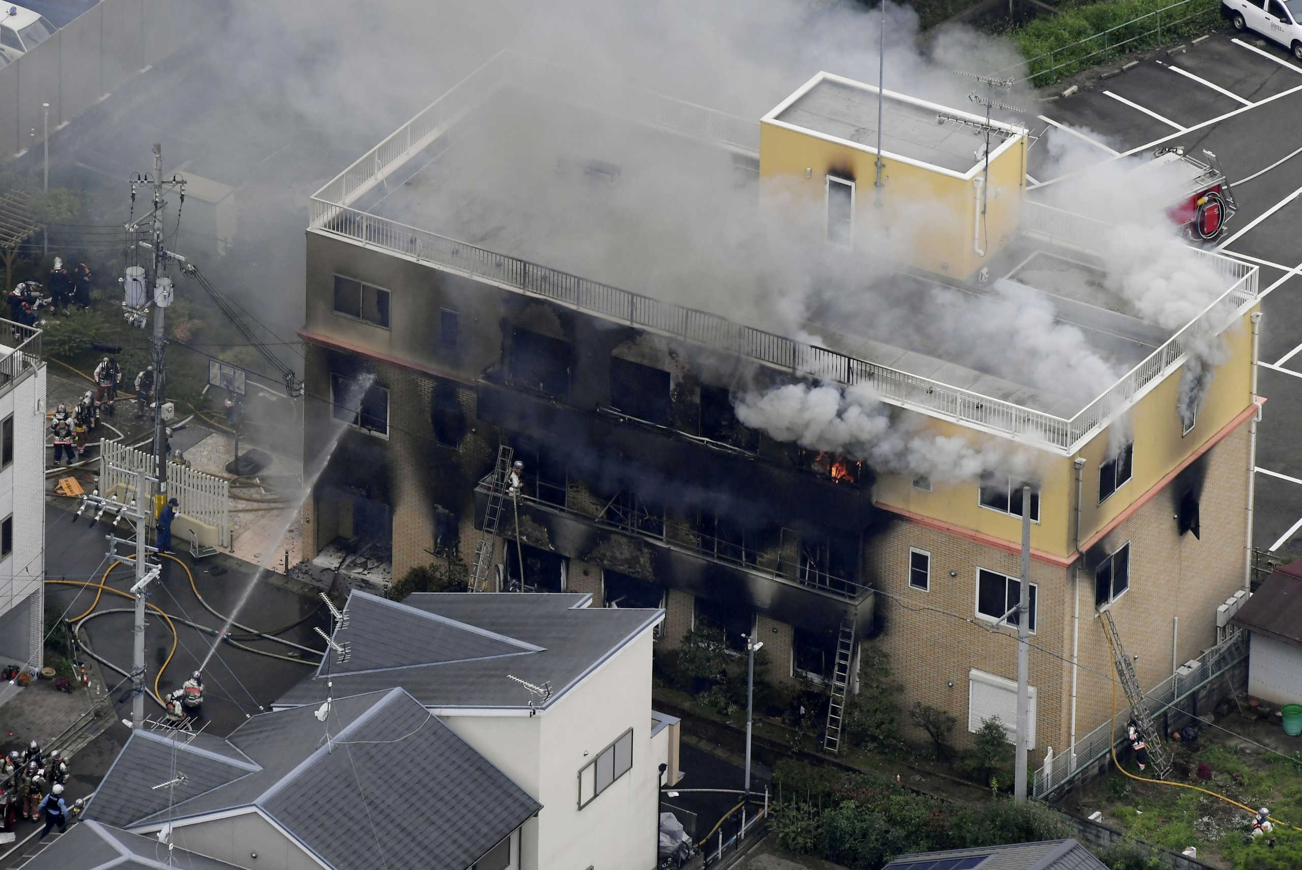 FILE PHOTO : An aerial view shows firefighters battling fires at the site where a man started a fire after spraying a liquid at a three-story studio of Kyoto Animation Co. in Kyoto, western Japan, in this photo taken by Kyodo, July 18, 2019. Mandatory credit Kyodo