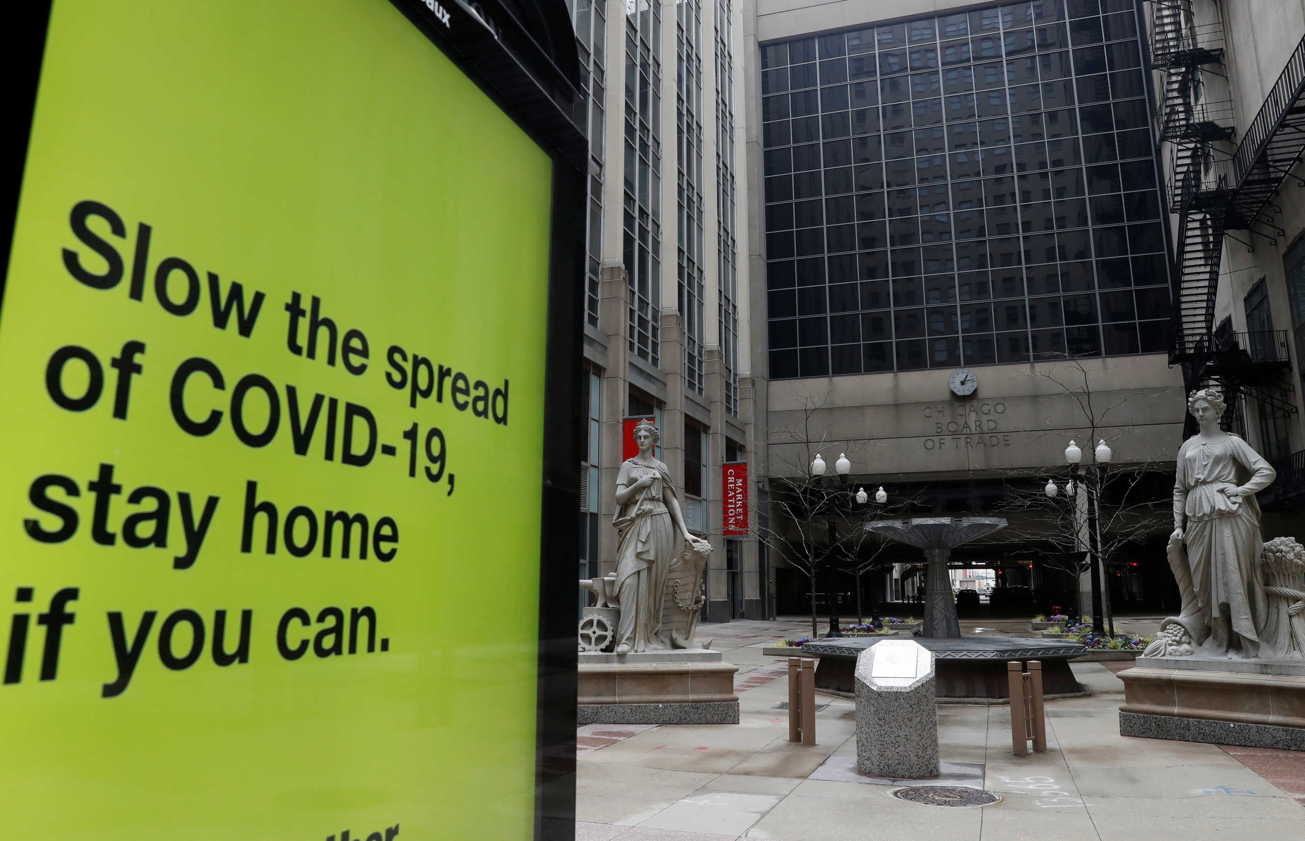 A sign warning of the spread of the coronavirus disease (COVID-19) is seen in front of the closed Chicago Board of Trade in Chicago, Illinois, U.S., April 23, 2020.  REUTERS