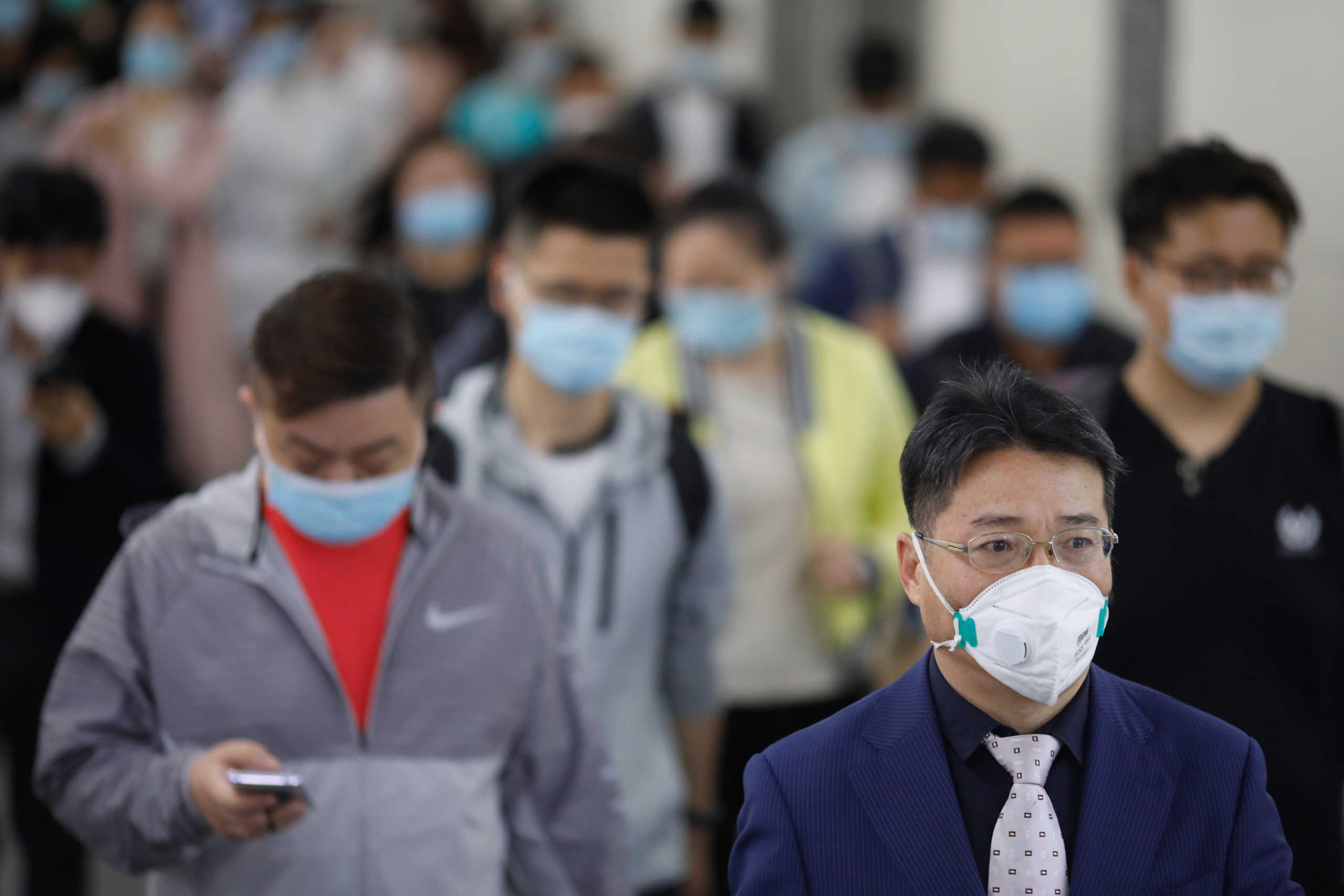 People wearing face masks walk inside a subway station during morning rush hour, following an outbreak of the coronavirus disease (COVID-19), in Beijing, China May 11, 2020. REUTERS