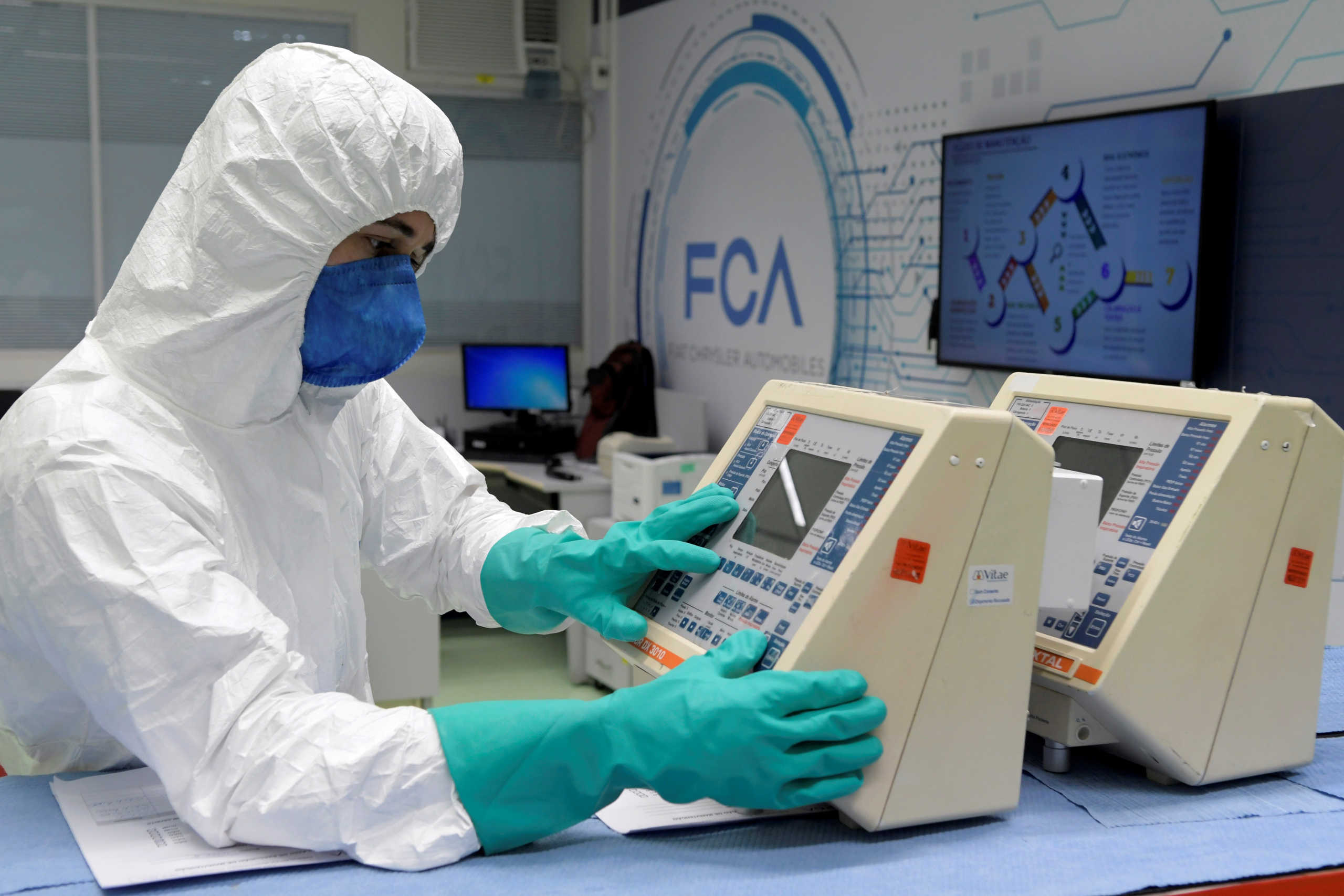 FILE PHOTO: A technician from FCA (Fiat Chrysler Automobiles) assembly plant fixes respirators for use in hospitals at the company's lab, amid the coronavirus disease (COVID-19) outbreak, in Betim near Belo Horizonte, Brazil, April 8, 2020. REUTERS