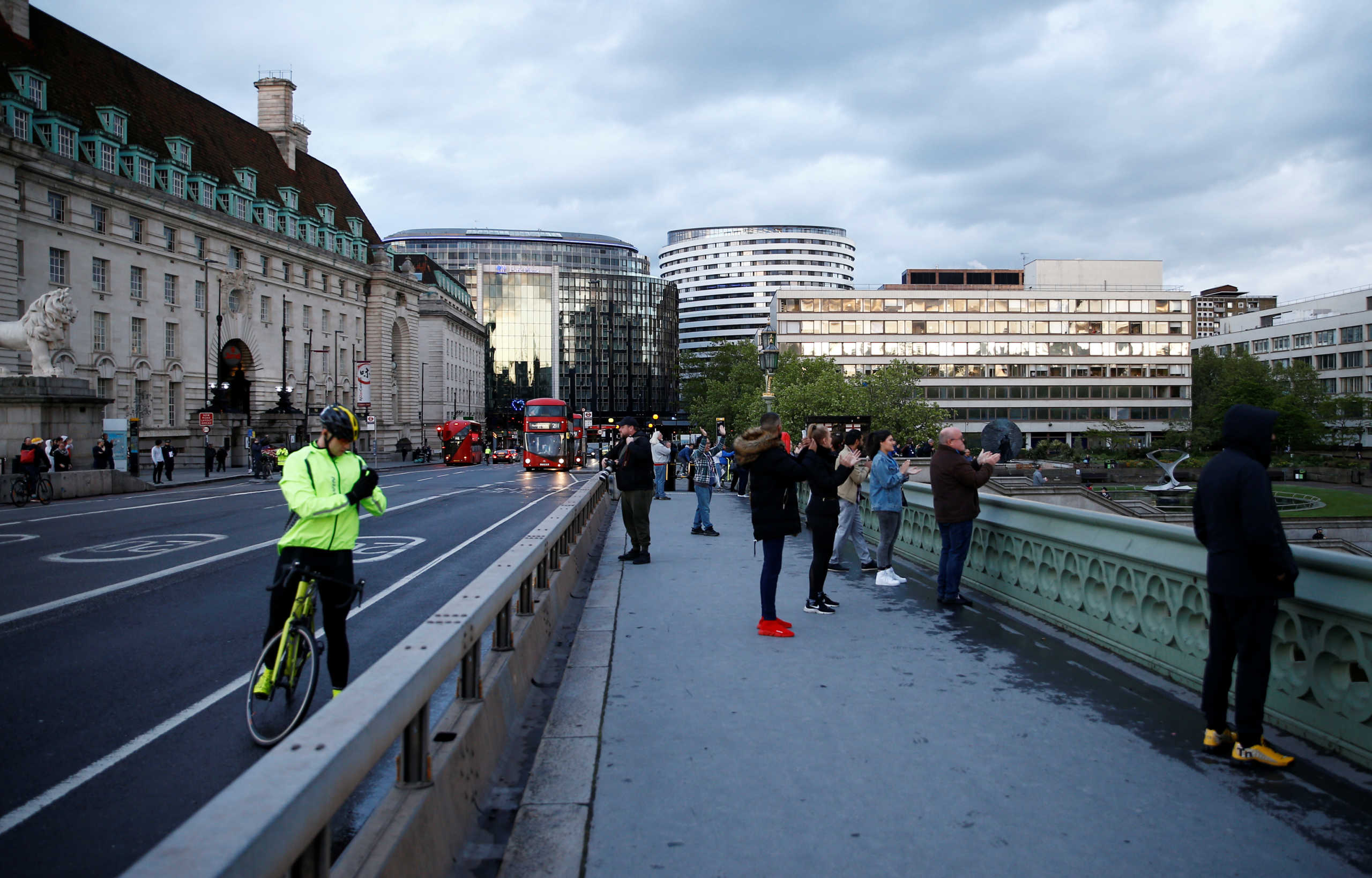 People applaud on Westminster Bridge in support of the NHS is seen before the Clap for our Carers campaign, following the outbreak of the coronavirus disease (COVID-19), in London, Britain, April 30, 2020. REUTERS