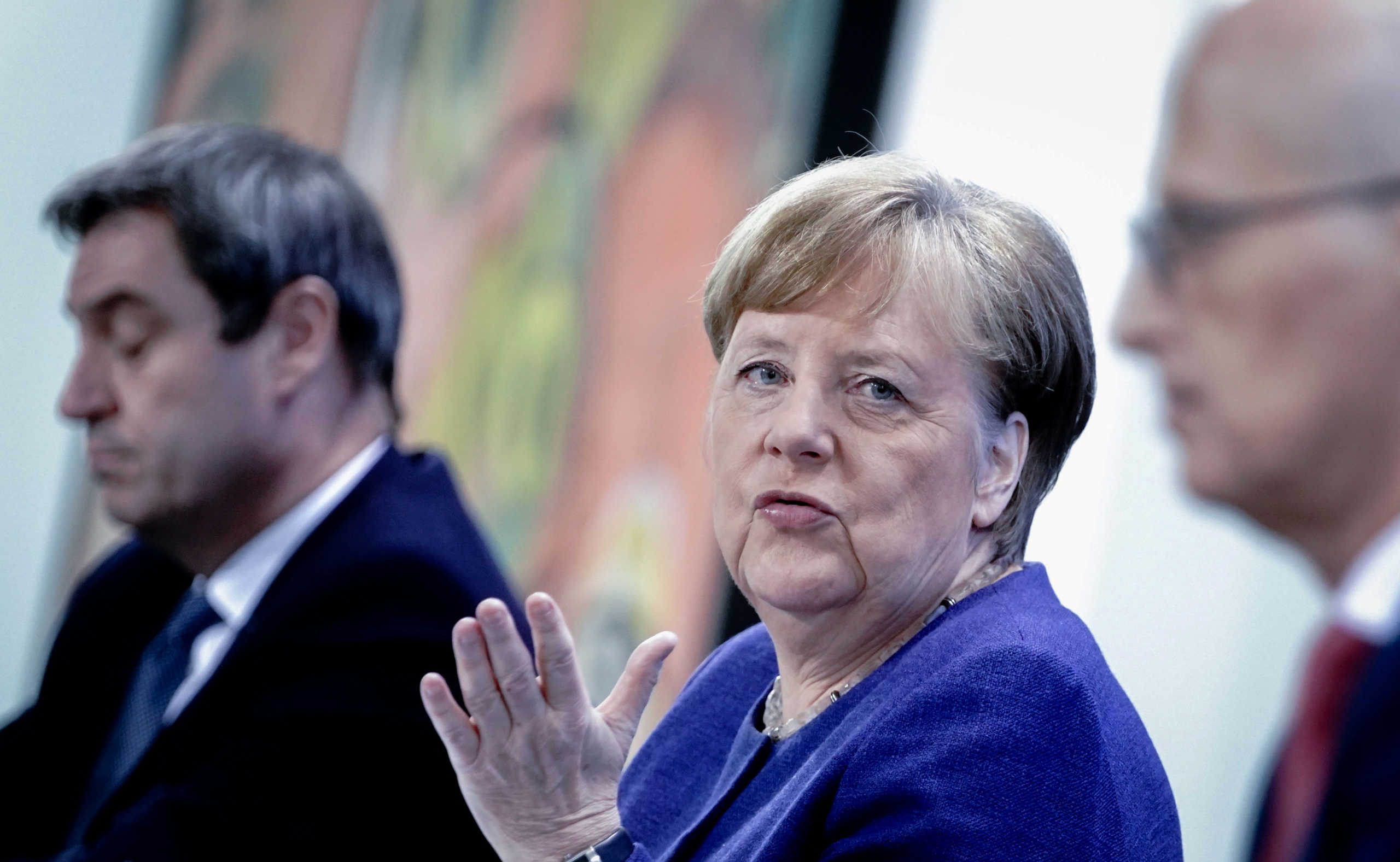 German Chancellor Angela Merkel, Bavarian Prime Minister Markus Soeder and Hamburg mayor Peter Tschentscher attend a news conference after discussing with German state premiers whether the regulations imposed to limit the spread of the coronavirus disease (COVID-19) need relaxing, at the Chancellery in Berlin, Germany, April 30, 2020. Kay Nietfeld