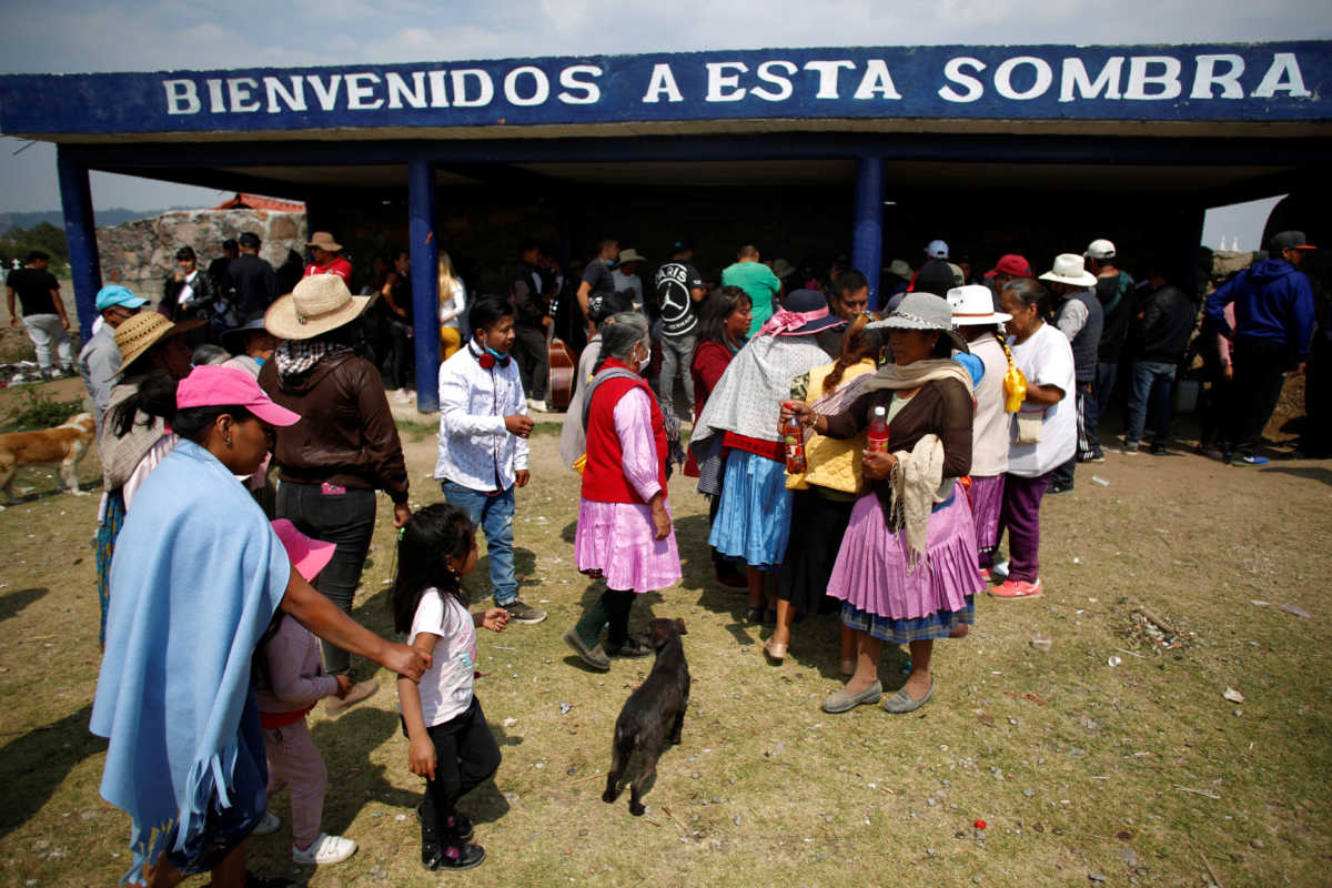 Mourners gather for a ceremony according to indigenous Mazahua tradition following the burial of Horacio Servando Parada, 65, who died of the coronavirus disease (COVID-19), in San Antonio Pueblo Nuevo, in the state of Mexico, Mexico May 21, 2020. Picture taken May 21, 2020. REUTERS
