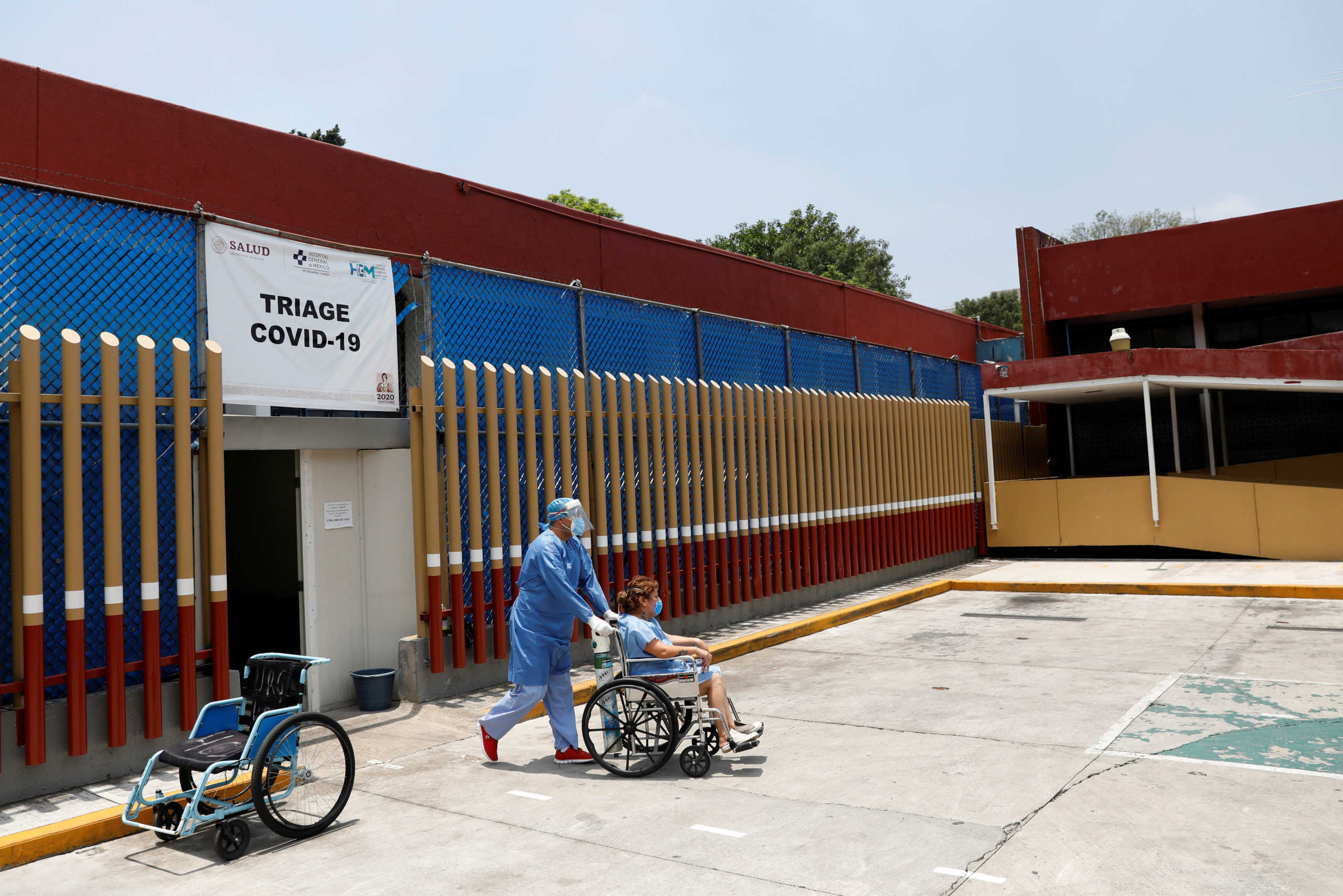 A health worker wearing protective suit transports a woman suspected of being infected with the coronavirus disease (COVID-19) at Hospital General de Mexico, as the outbreak of the coronavirus disease (COVID-19) continues in Mexico City, Mexico May 10, 2020. REUTERS