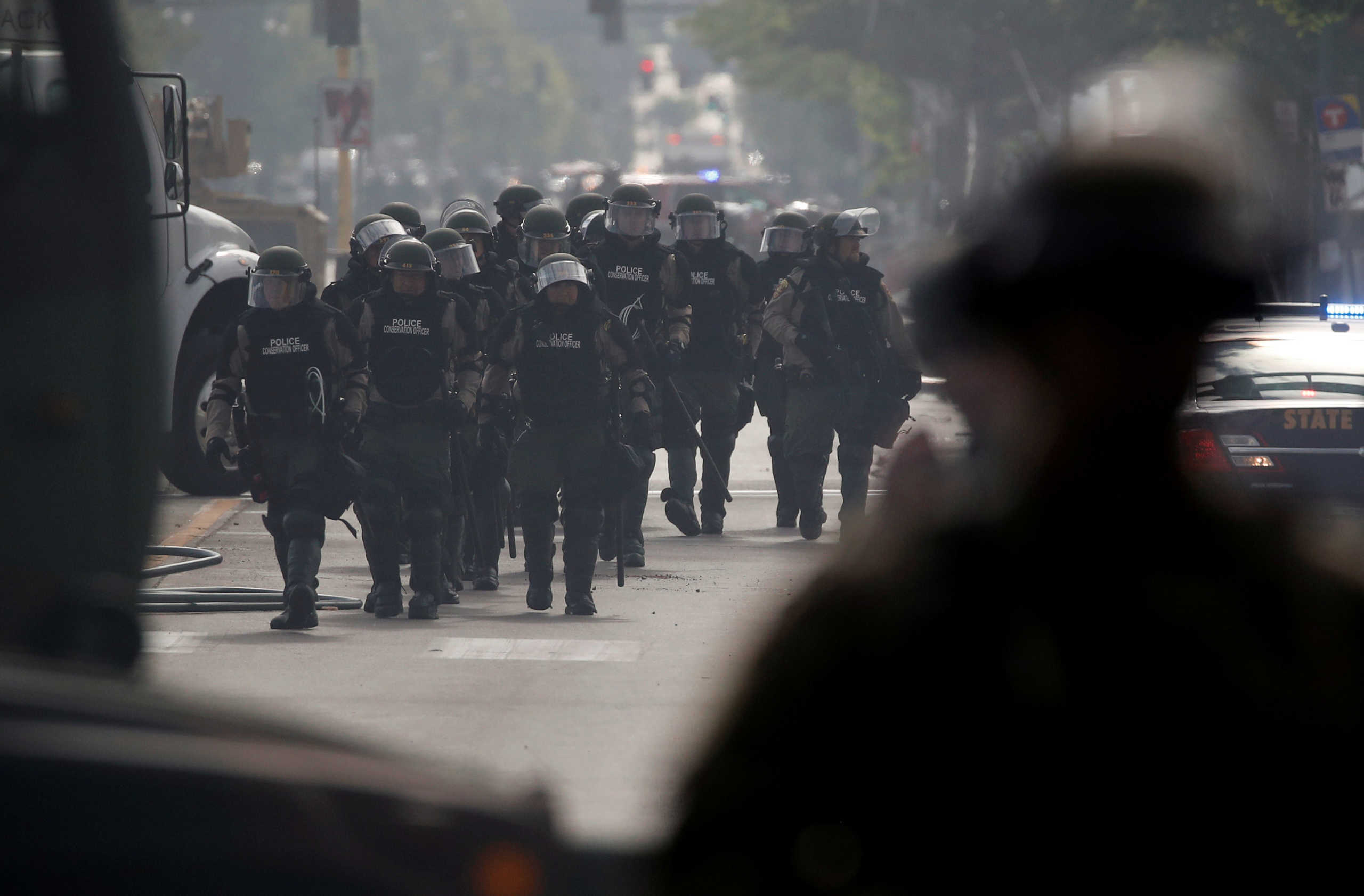 Police conservation officers walk at the area in the aftermath of a protest after a white police officer was caught on a bystander's video pressing his knee into the neck of African-American man George Floyd, who later died at a hospital, in Minneapolis, Minnesota, U.S., May 29, 2020. REUTERS