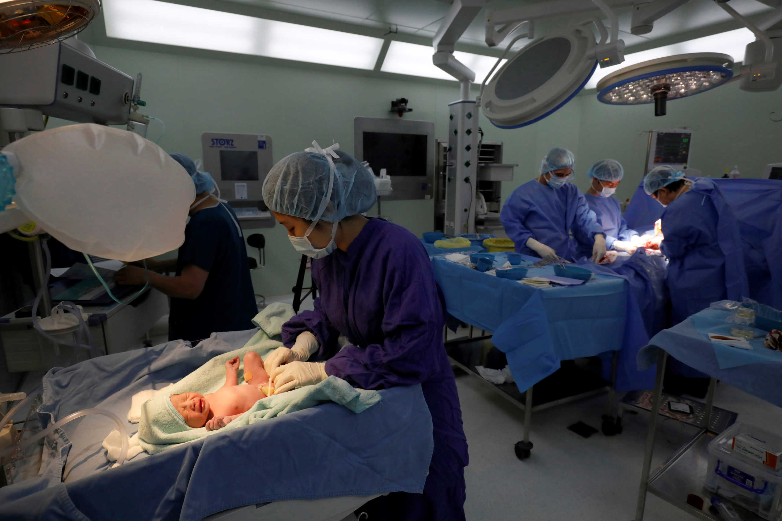 A nurse attends to newborn baby Phuc An after he was born in Vinmec hospital during the coronavirus disease (COVID-19) outbreak in Hanoi, Vietnam April 1, 2020. Phuc An was born at Vinmec hospital in Hanoi on April 1, when the Southeast Asian country started its strict restrictions on movement to contain the spread of the coronavirus that has infected more than 3 million people worldwide. The three-week lockdown put most of the social and economic activities throughout the country on hold, but life must go on, and giving birth couldn?t be delayed. Picture taken April 1, 2020.  REUTERS