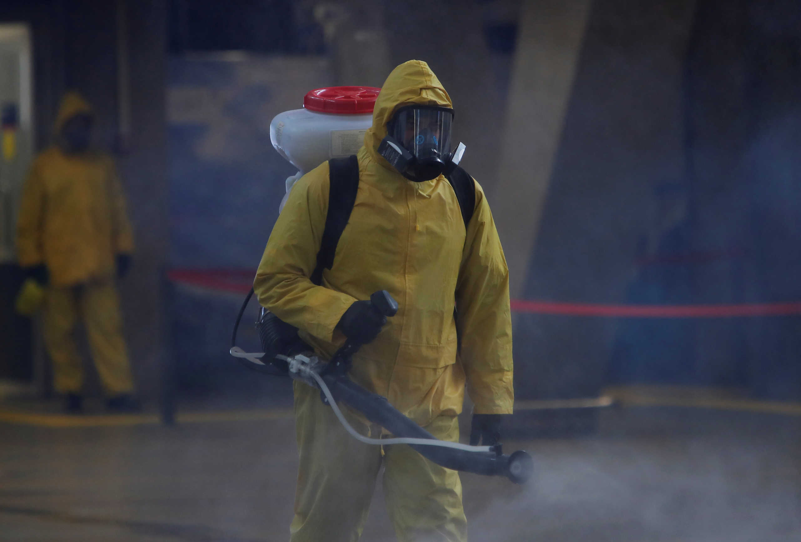 A member of the Russian Emergencies Ministry wearing protective gear sprays disinfectant while sanitizing the Leningradsky railway station amid the outbreak of the coronavirus disease (COVID-19) in Moscow, Russia May 19, 2020. REUTERS