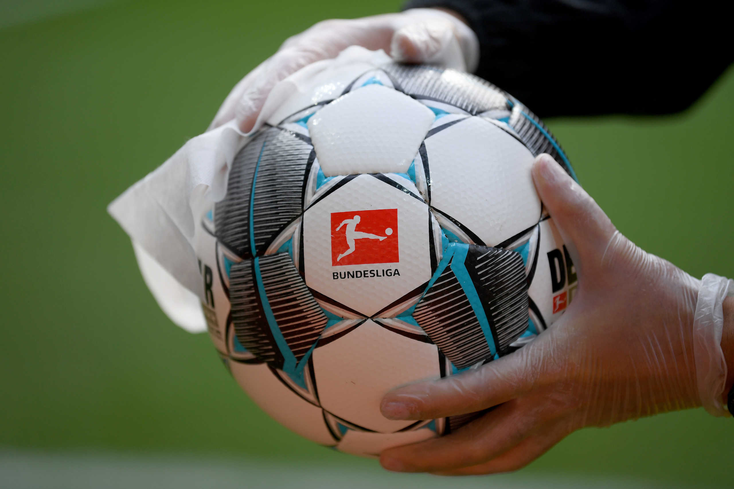 Soccer Football - Bundesliga - Werder Bremen v Bayer Leverkusen - Weser-Stadion, Bremen, Germany - May 18, 2020 A matchball is disinfected before the match, as play resumes behind closed doors following the outbreak of the coronavirus disease (COVID-19) Stuart Franklin